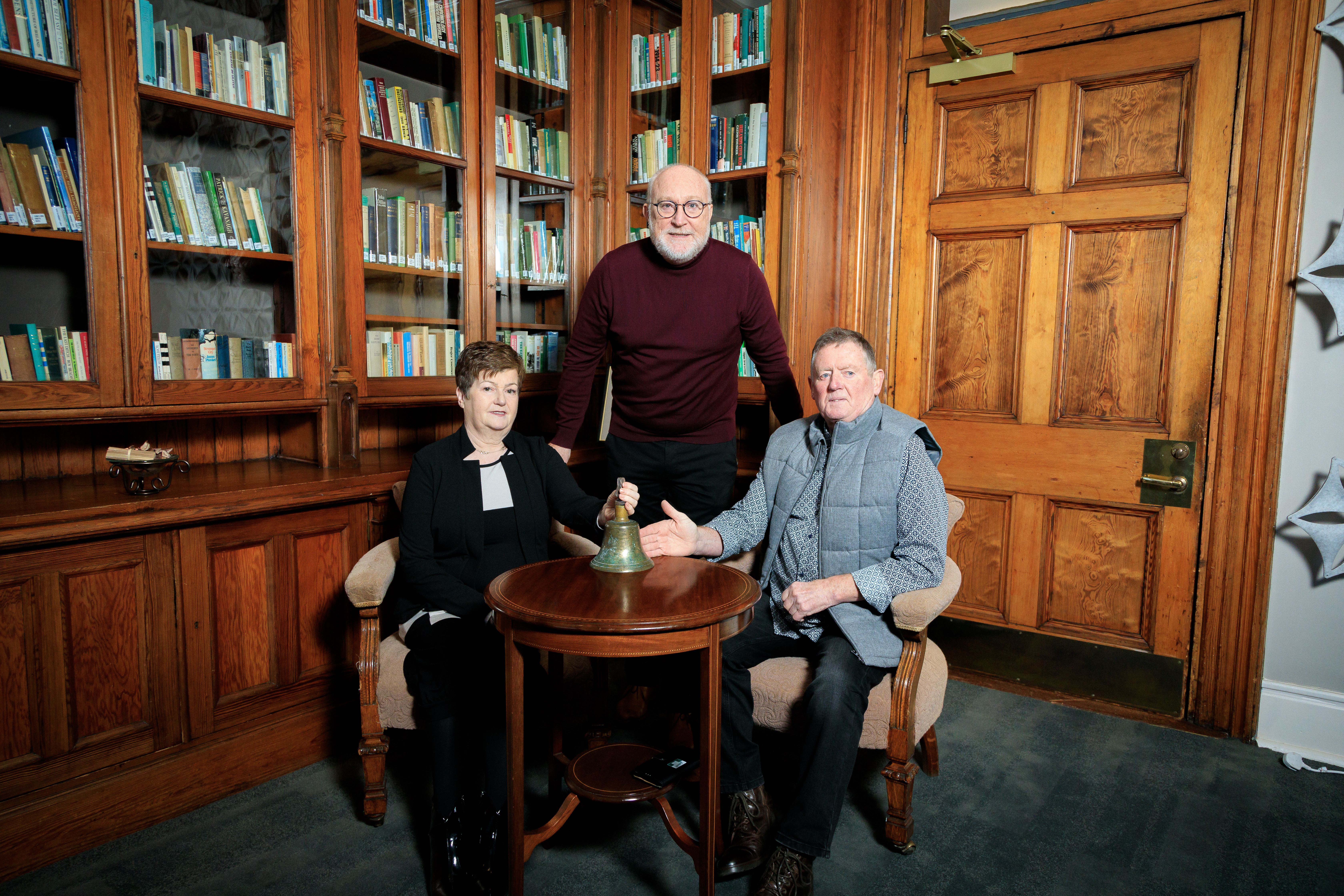 NEW SURROUNDINGS: Professor Peter Finn with Ray Loughran and Barbara Kennedy and the old Trench House bell