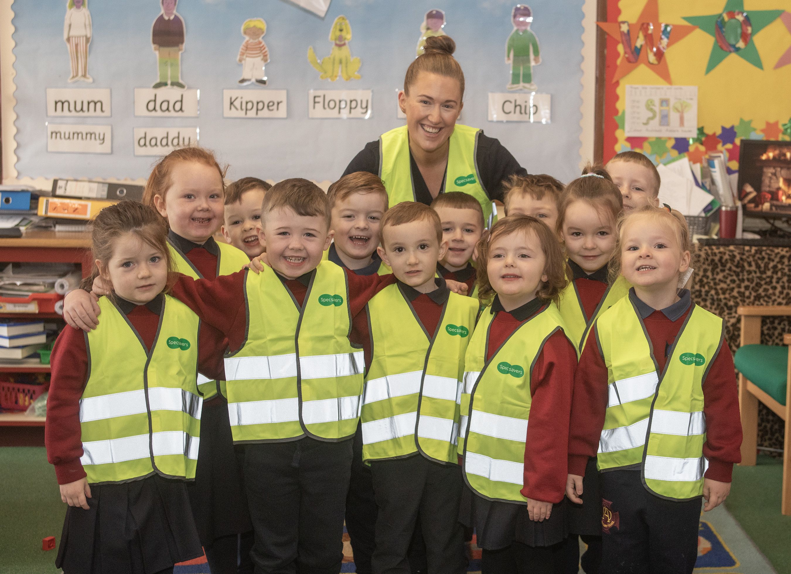 ROAD SAFETY: St Oliver Plunkett Primary School pupils in their hi vis vests with Specsavers Park Centre staff member Louise Shortt