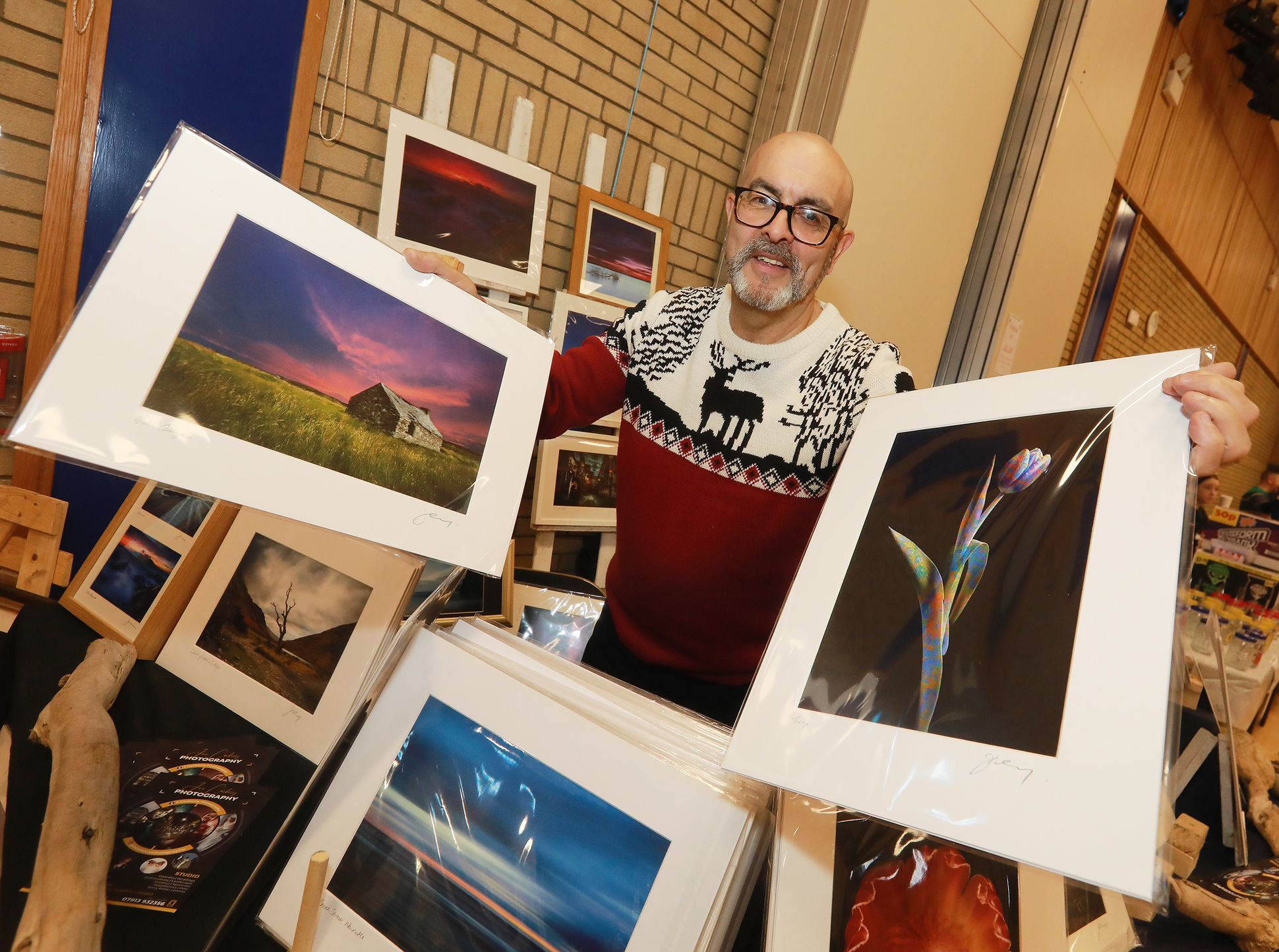 Photographer Joe Carberry with his photos