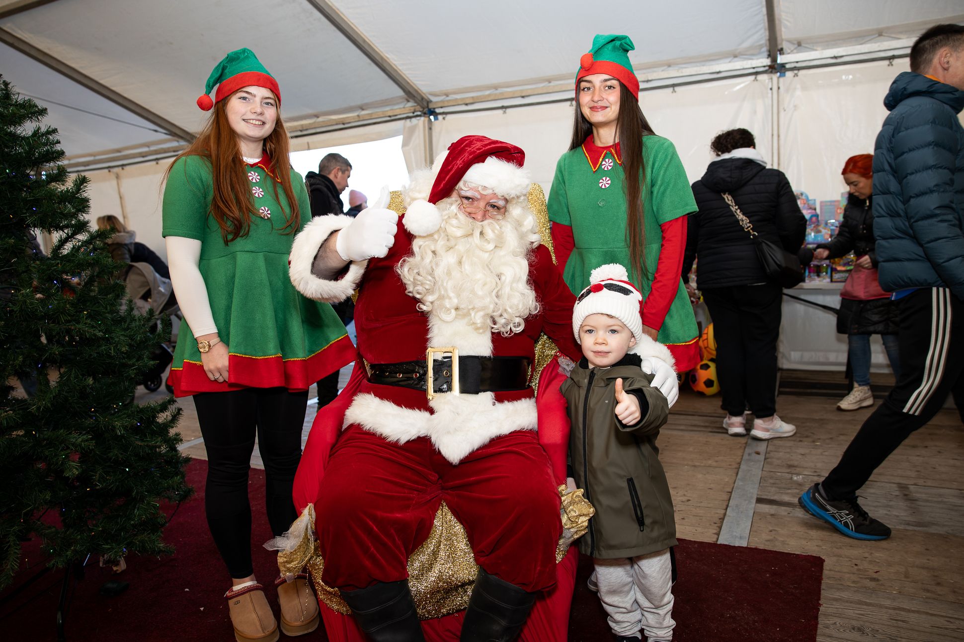 Shea McAufield with Santa Claus and elves Liosa Stone and Cara Lynch