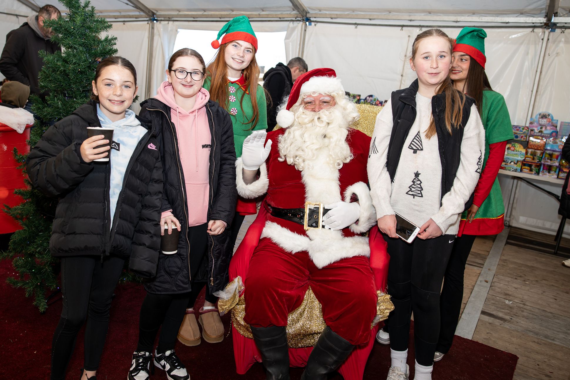 Holly McFall, Caoimhe McElvanna, Eva Curran with Santa Claus and elves Liosa Stone and Cara Lynch