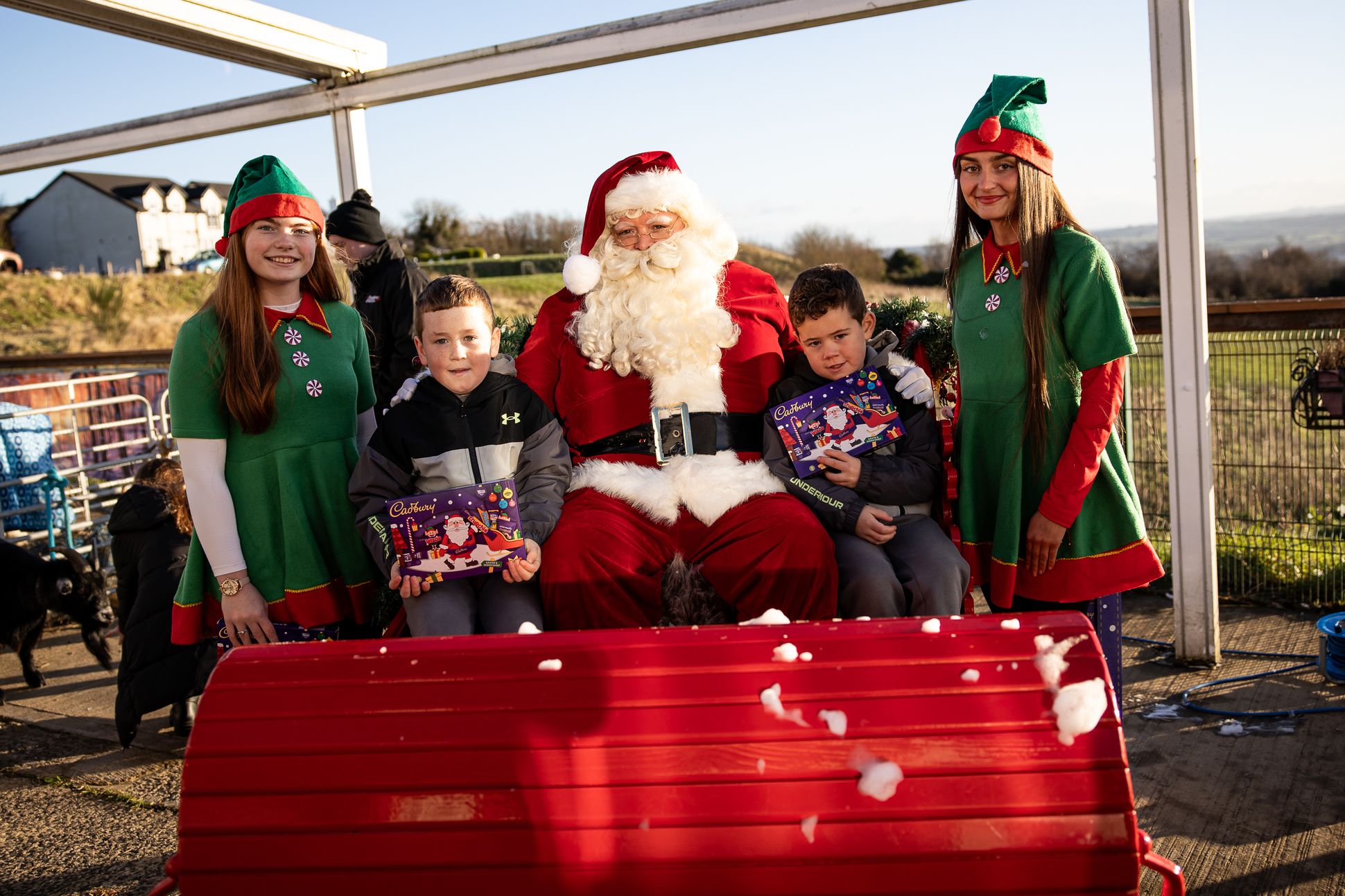 Jonah and Jack McCrudden with Santa Claus and elves Liosa Stone and Cara Lynch