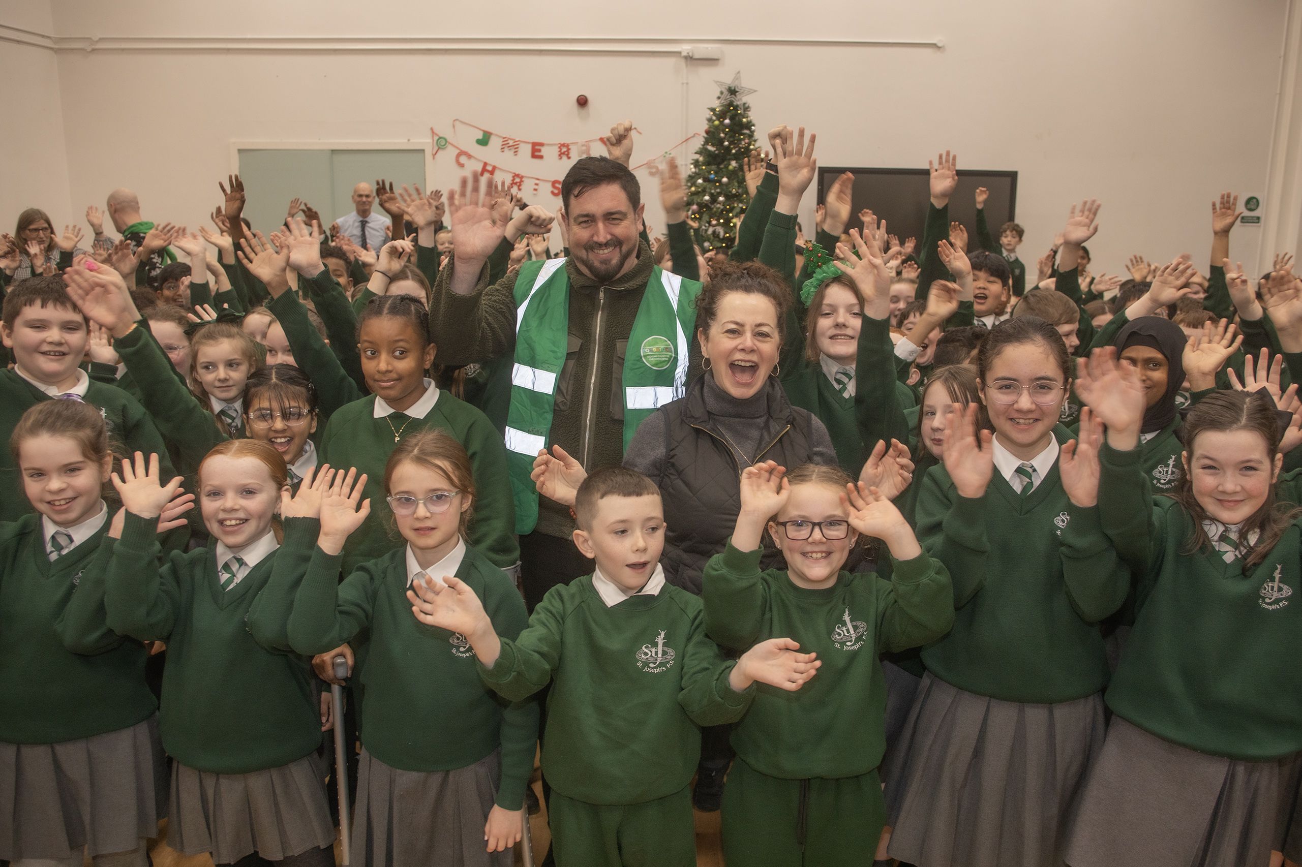 ALL SMILES: Actress Geraldine Hughes and Paul Doherty from Foodstock with pupils from St Joseph\'s PS