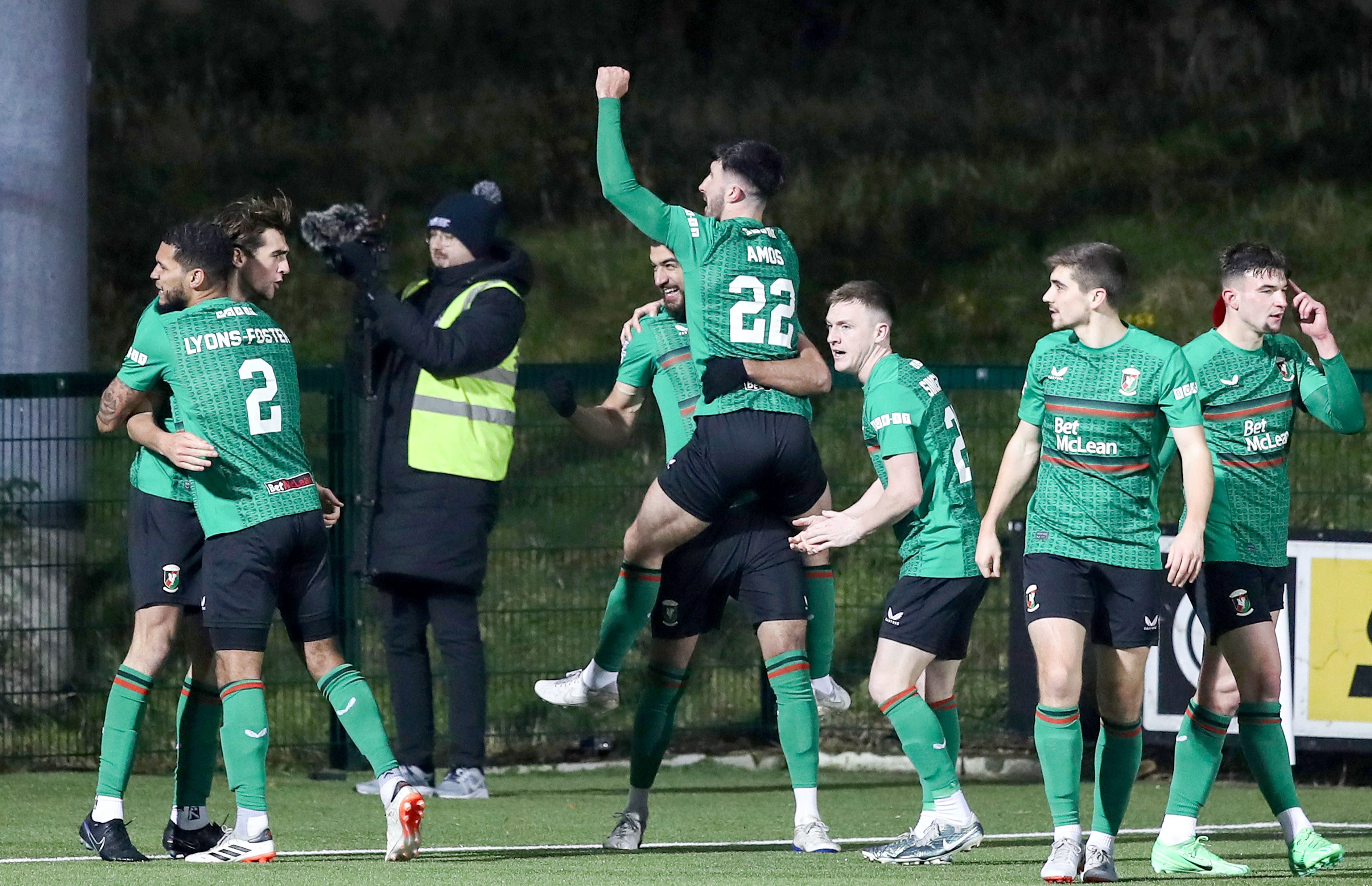 Daniel Amos is mobbed after scoring what proved to be the winner