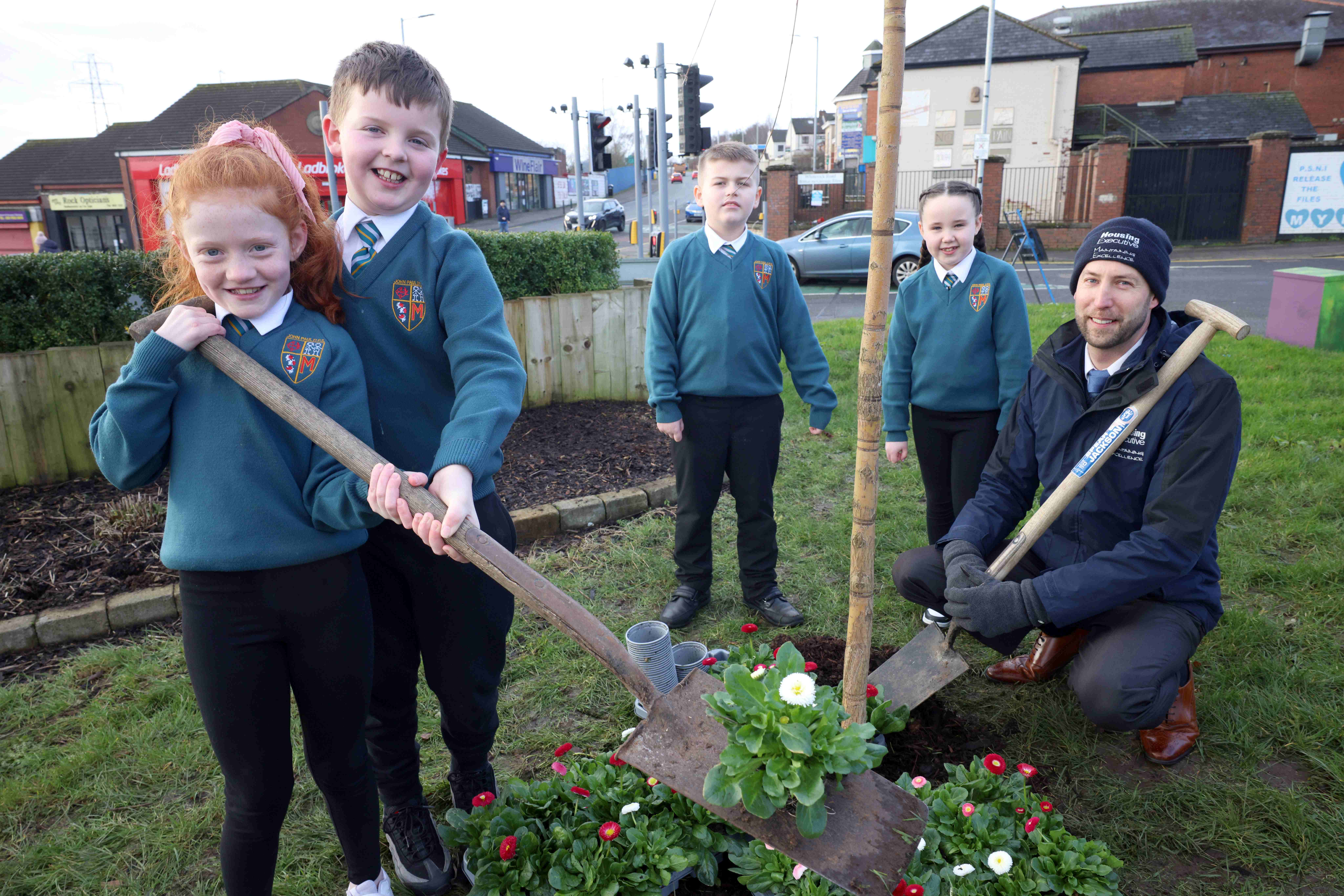 DIGGING IN: Rebecca, Alexander, Sean and Carly from John Paul II Primary School with Housing Executive’s grounds maintenance supervisor John Ingram