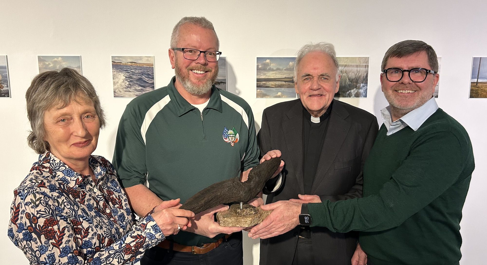 SHOULDER-TO-SHOULDER: Geraldine Finucane, Fr Aidan Tory and Mark Thompson present a bog oak artwork to Danny O\'Connell (second left)