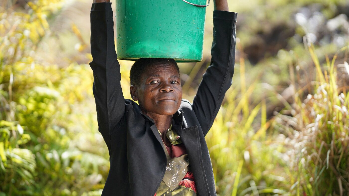 Salmon Jyambere stands in front of his house which was destroyed by flooding in Rwanda