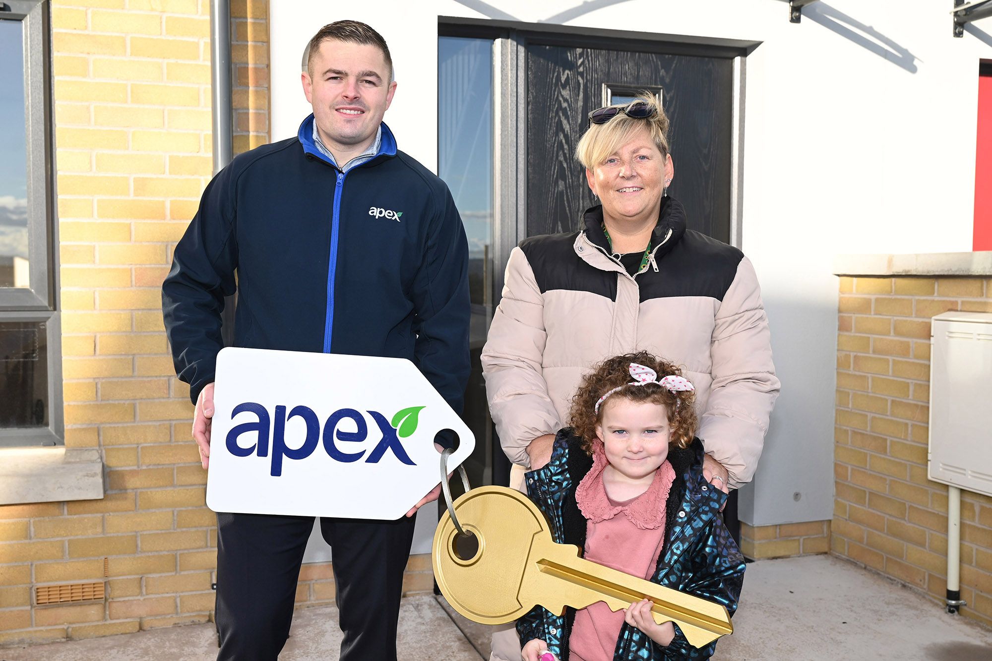 NEW HOME: Nicola Marshall and her daughter Fiadh getting the keys to their new home in Black Ridge View. They are joined by Harry Dyer from Apex Housing Association
