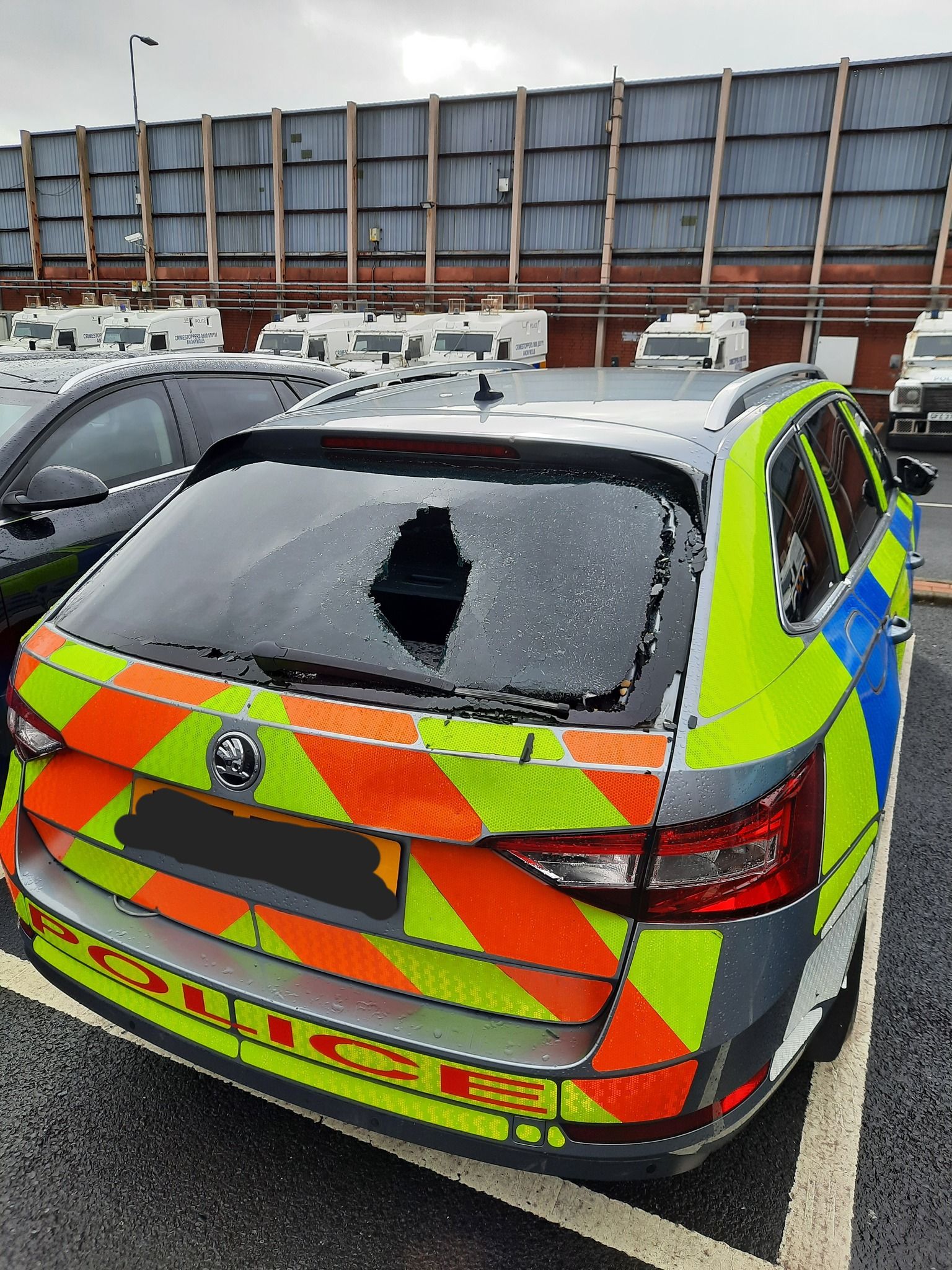SHATTERED: The back windscreens of two police vehicles were damaged