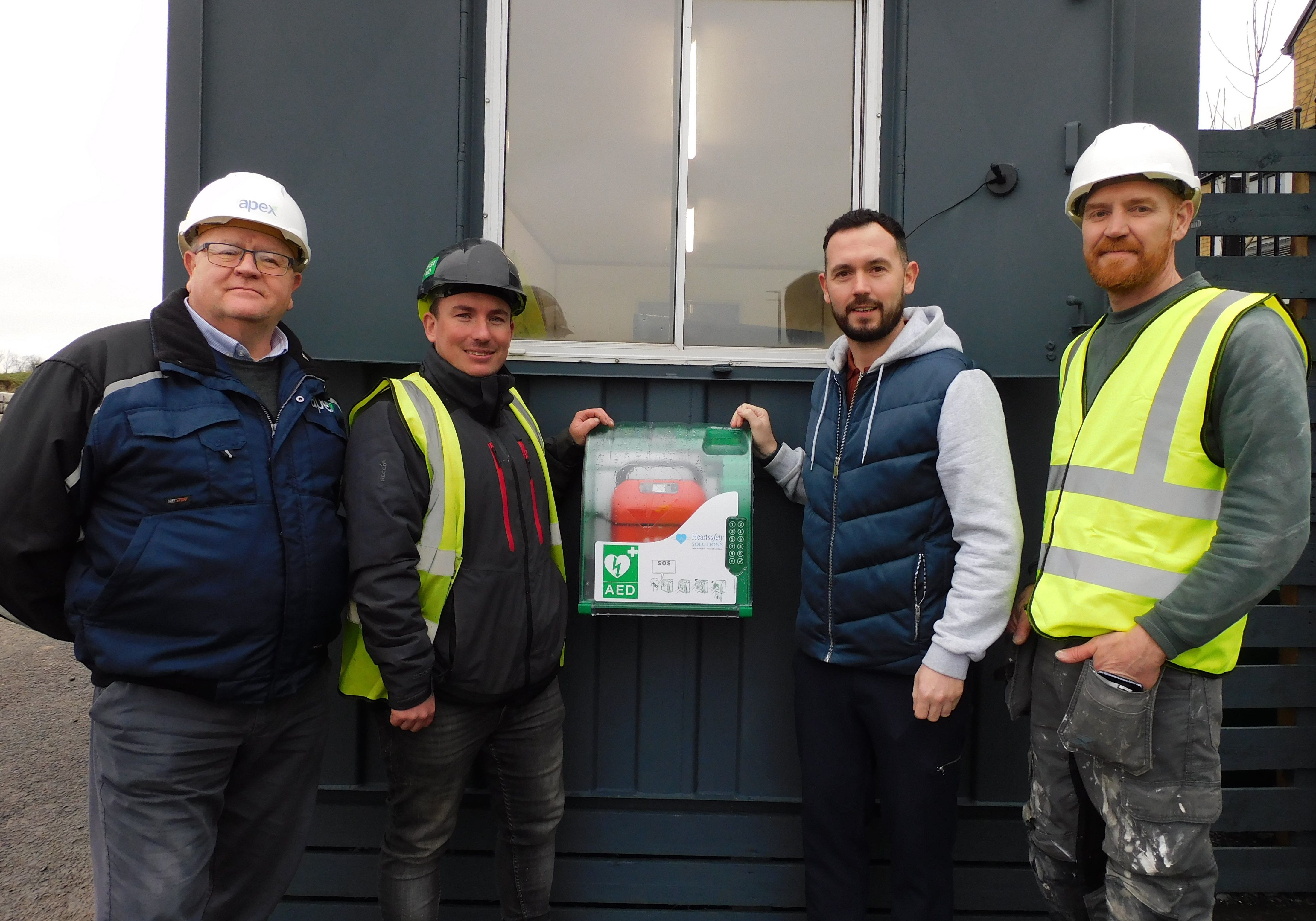 LIFE-SAVING: John Smith, Clerk of Works, Apex Housing Association; Alastair Jackson, Site Manager, Braidwater Group; Micheal Donnelly, Community Development Manager, Upper Springfield Development Trust; and GarethGamble, Site Manager,