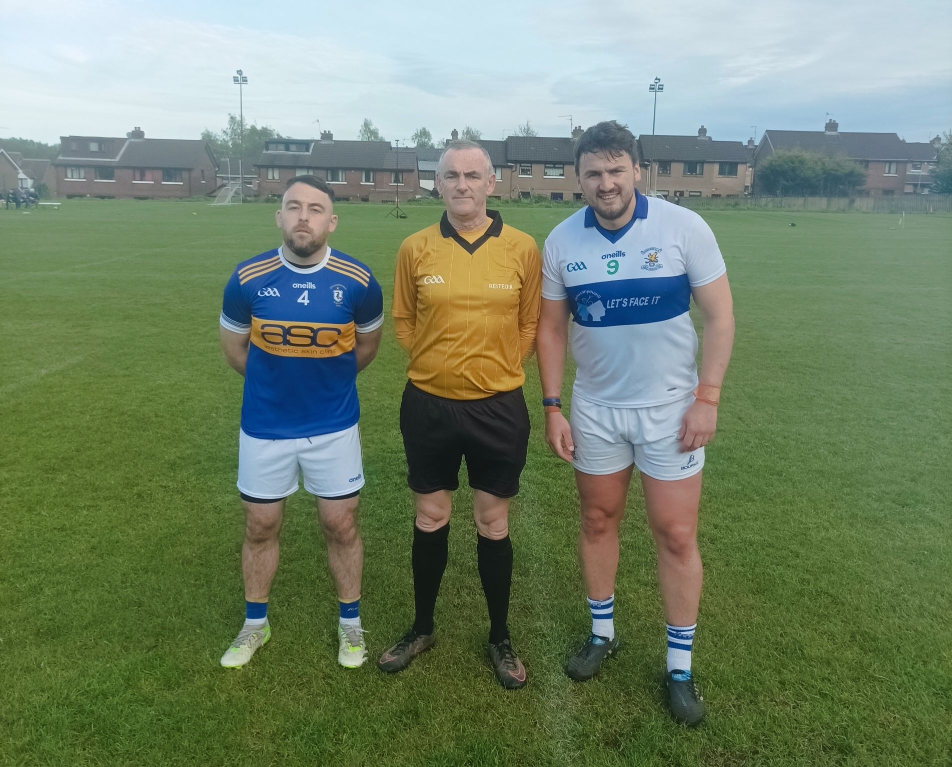 Referee Fionntan McCotter with Rossa\'s Niall Crossan and Domhnall Nugget from St John\'s before the game