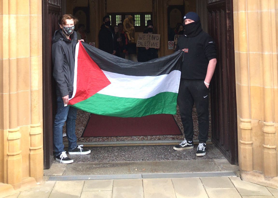 PROTEST: Students displaying a Palestinian flag at the Lanyon Building on Tuesday