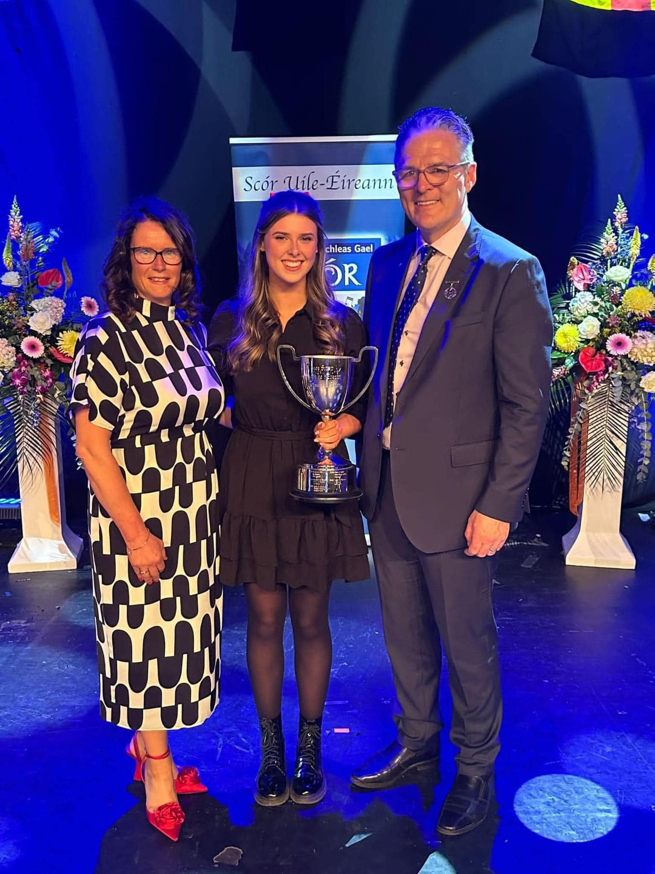 ALL-IRELAND SUCCESS: Méabh McNeill receives her cup and medal from National Scór Chairperson Paula Magee and GAA Uachtarán Jarlath Burns