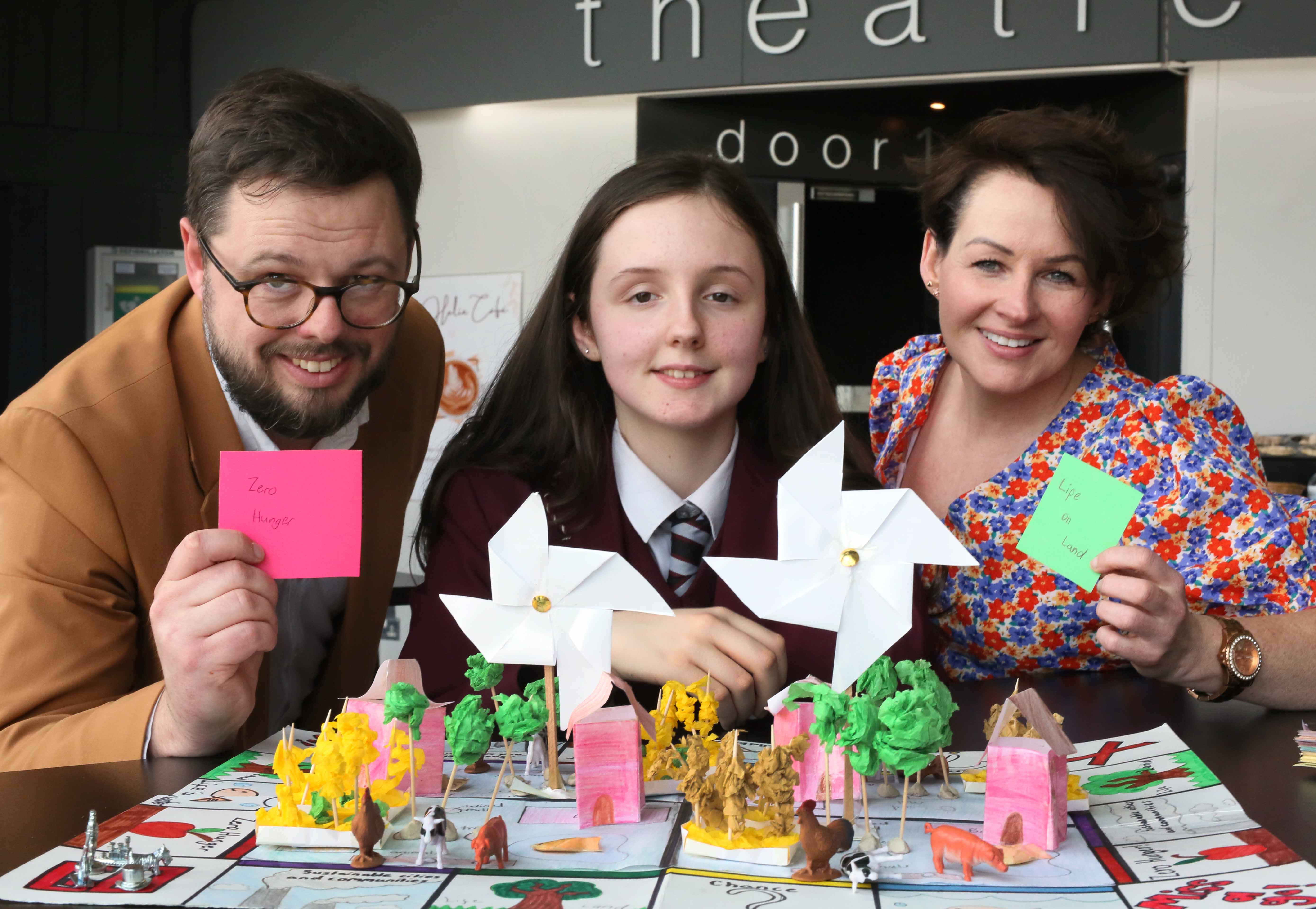 FIRST: Sophie Allely from St Dominic’s shows off the school’s winning entry with Trócaire NI region\'s Peter Heaney and Karen Casey, Head of Community Engagement and Outreach