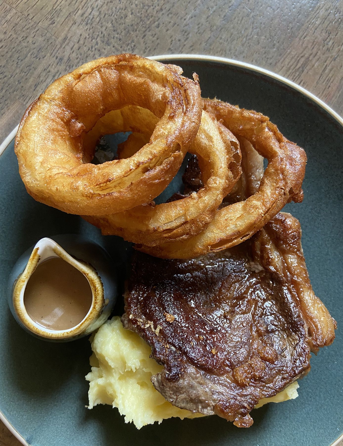 HIGHLIGHT: 8oz sirloin steak, served with crispy onion rings and peppercorn sauce