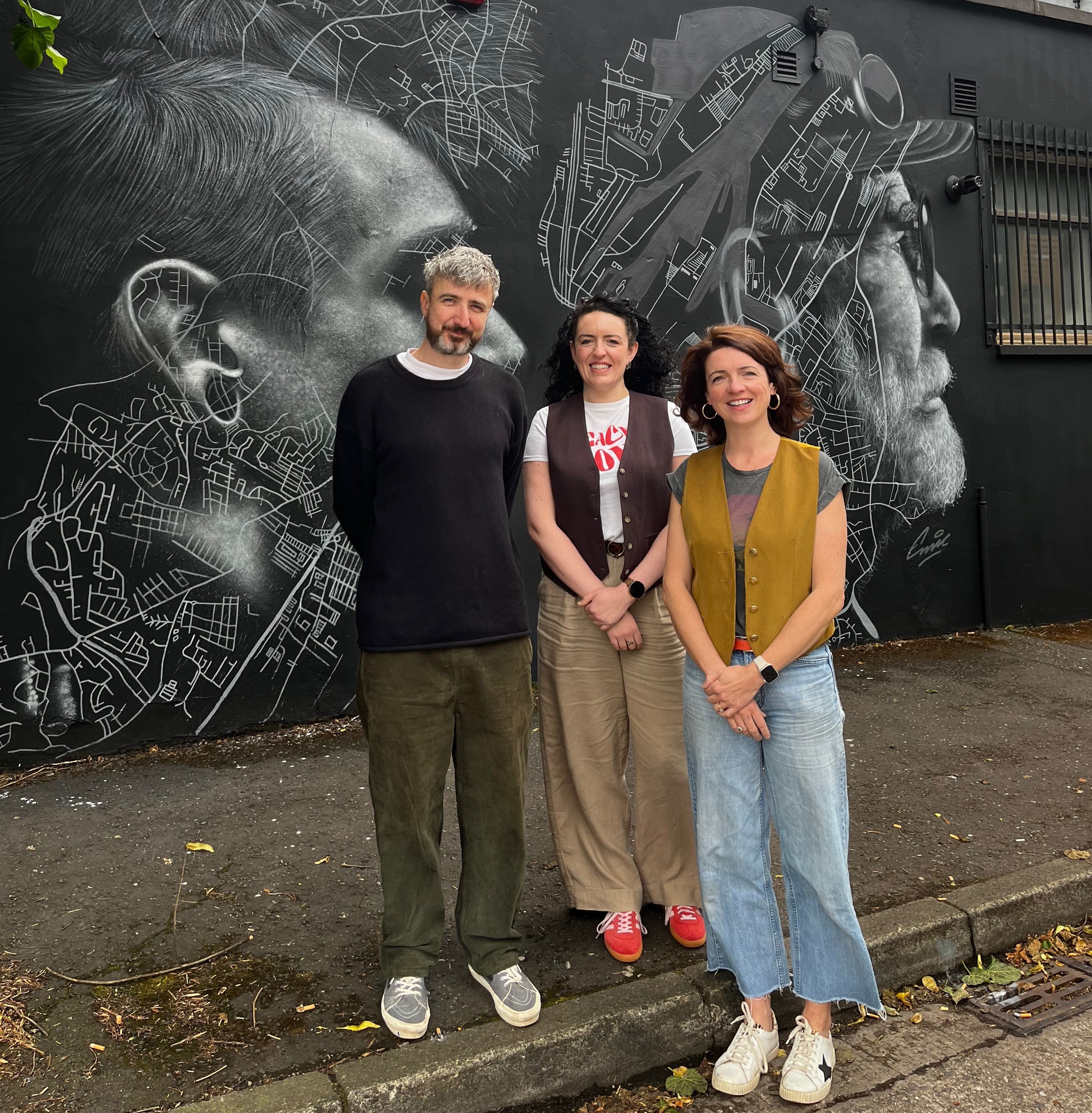 TRADING PLACES: Mural artist Eoin McGinn, Jenny Bond from Jenny Bond Interiors and Roisin Finnegan, Founder and Lead of the Assocation rolling out the red carpet