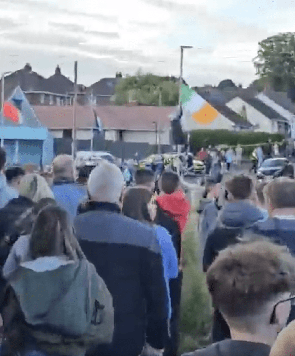 CROWD: The tricolour being torn down on Tuesday night