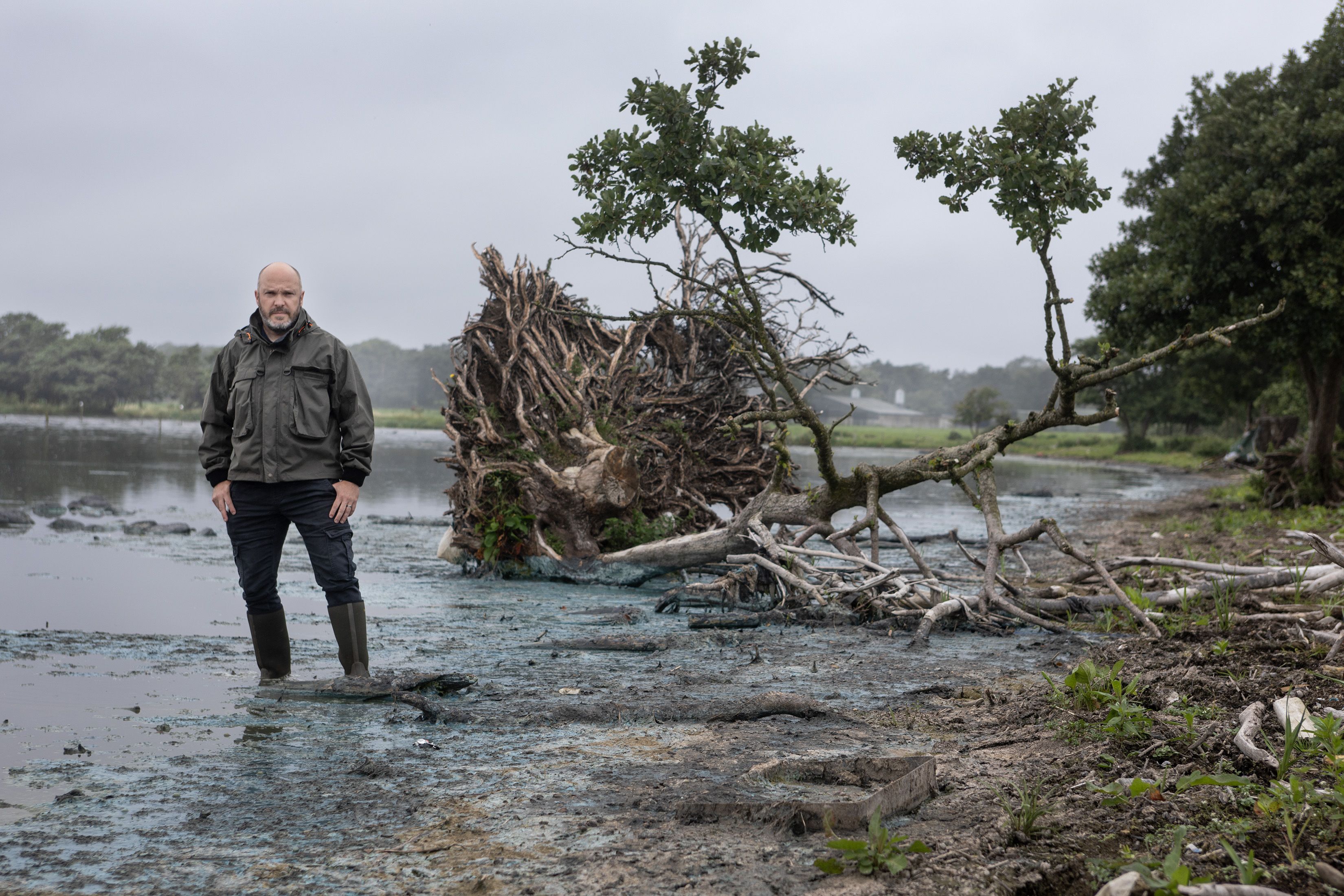 TOXIC: David Kennedy of Crumlin and District Angling Association walks amongst the blue-green algae on the shores of Lough Neagh