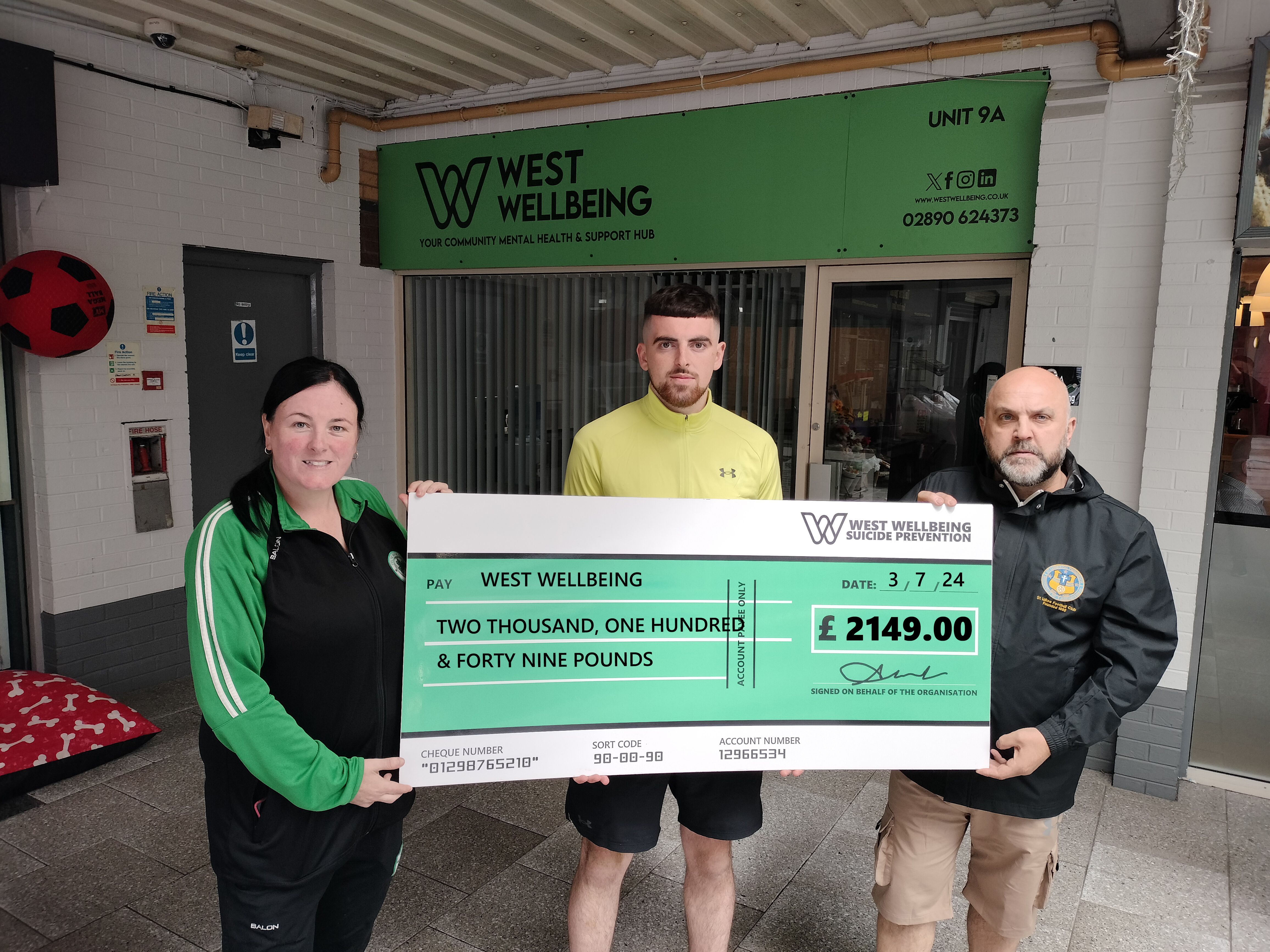 TWO GRAND GESTURE: Emma Morgan of Celtic Boys, Ciarán Walsh and JP McNally of St Luke\'s with their giant cheque donation for West Wellbeing