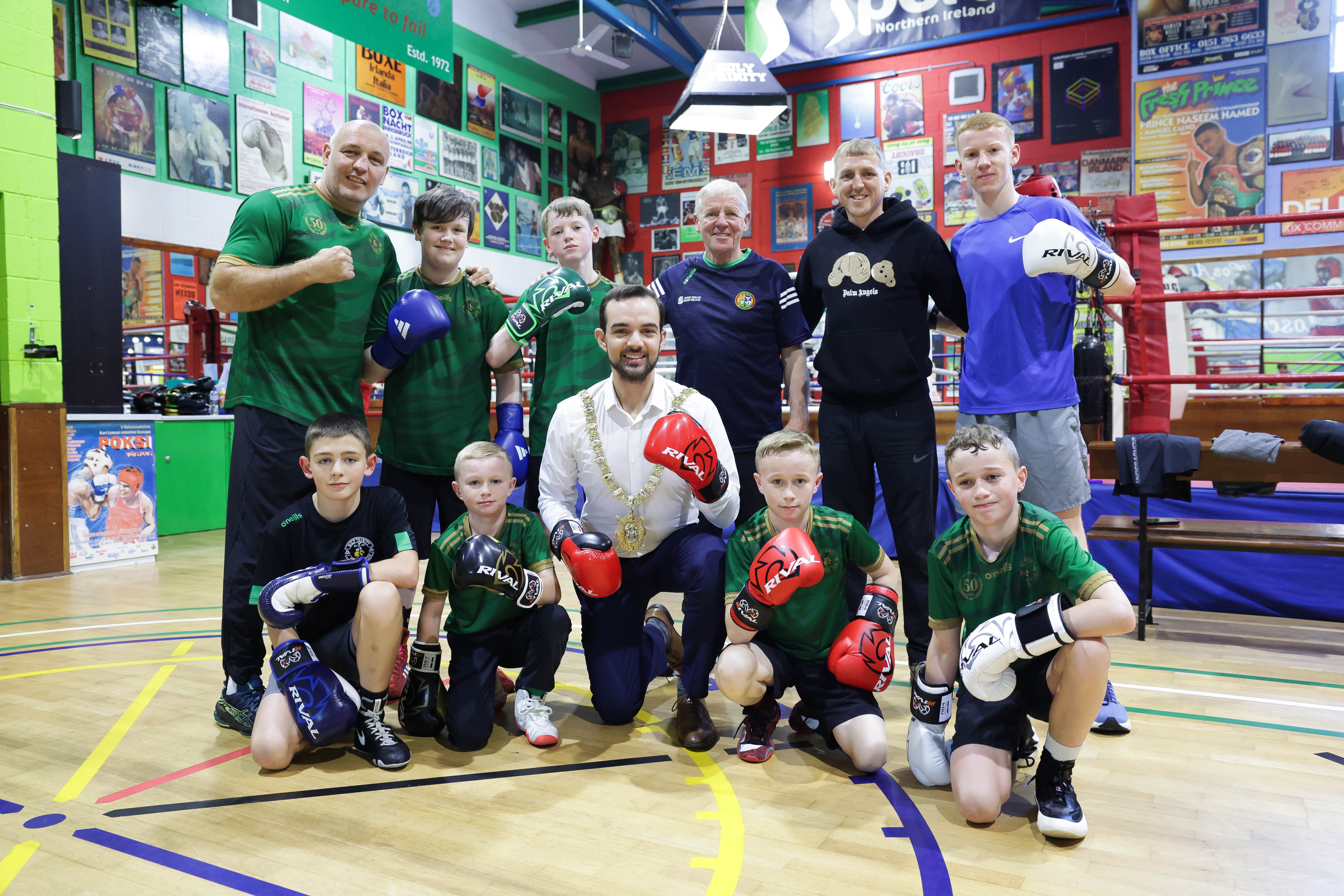 The Lord Mayor of Belfast, Councillor Micky Murray with Holy Trinity Boxing Club trainer, Mickey, Hawkins, former middleweight fighter Brian Magee and young members of the club.