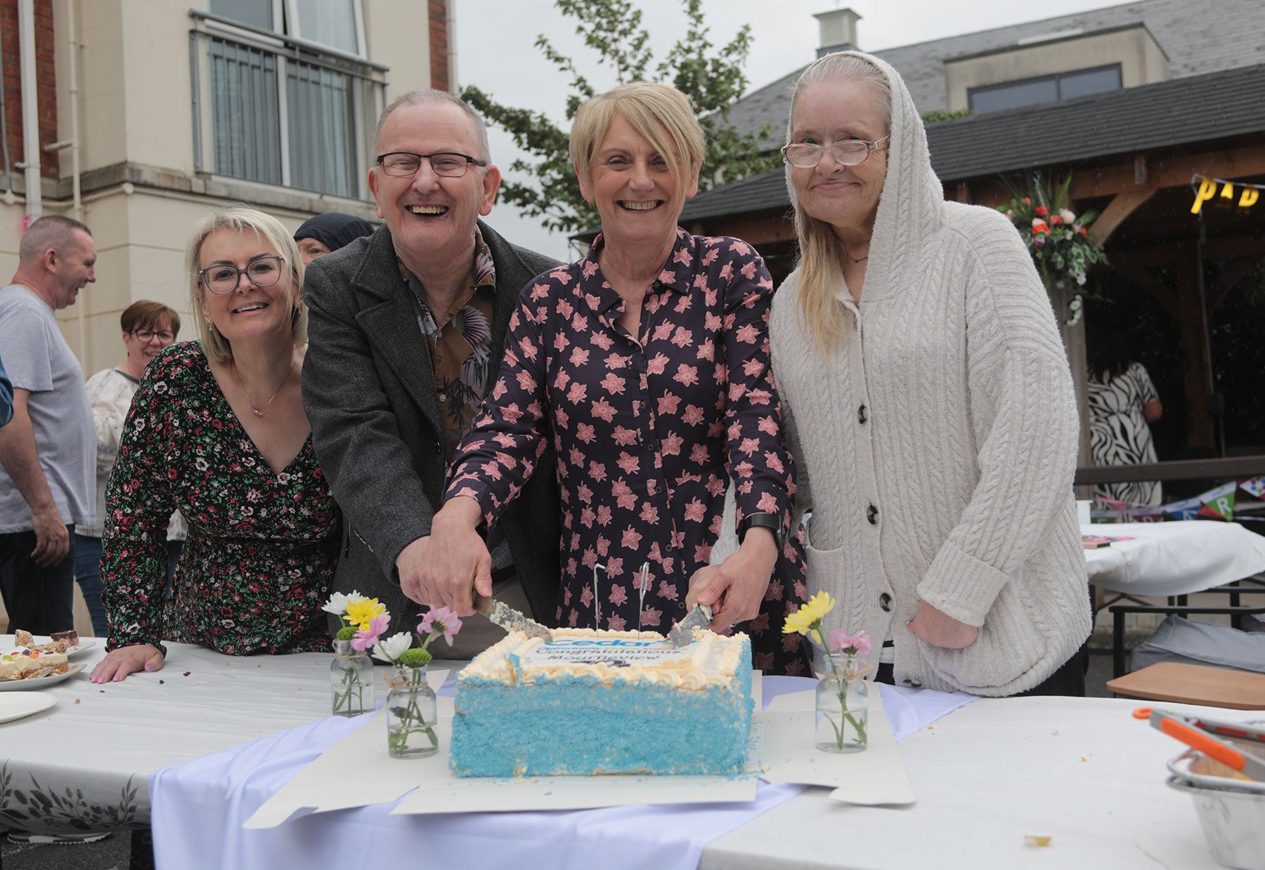 CUTTING THE CAKE: Jeanette McGeown (Head of Service, The Cedar Foundation), tenants Raymond Gorman and Anna Canavan, Susan Stewart (Registered Manager at Mourneview Court)