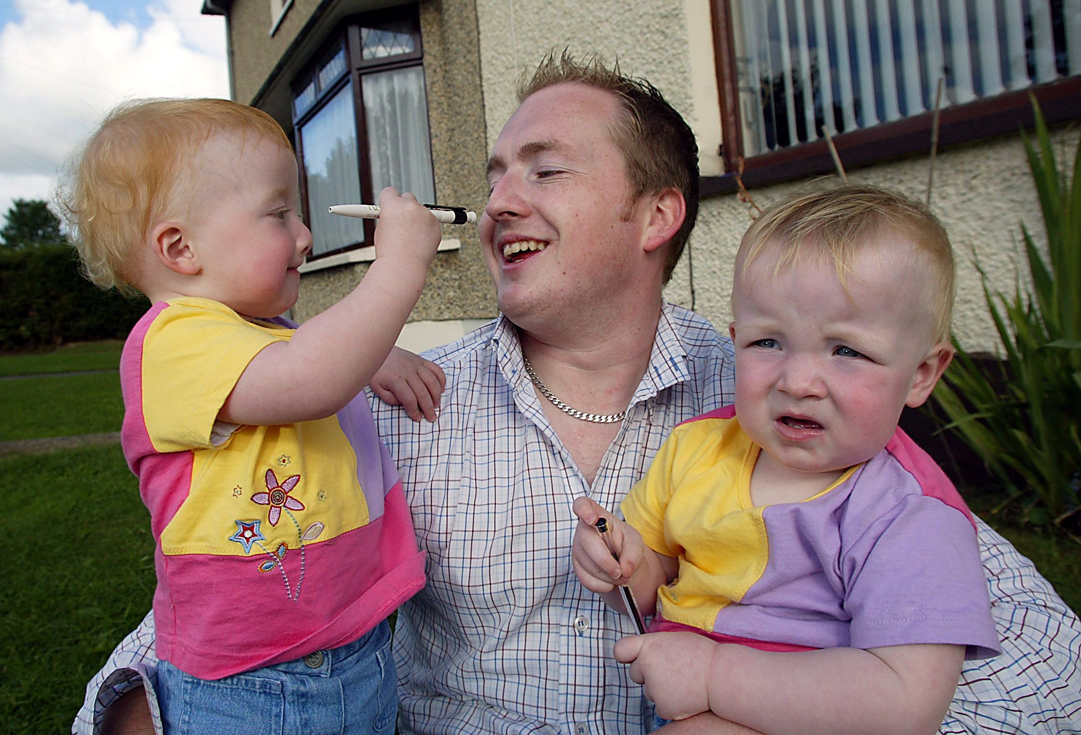 DOUBLE TROUBLE! Aisling Bursary recipient Kevin Grieve with his twin daughters Katie and Jane back in 2003.