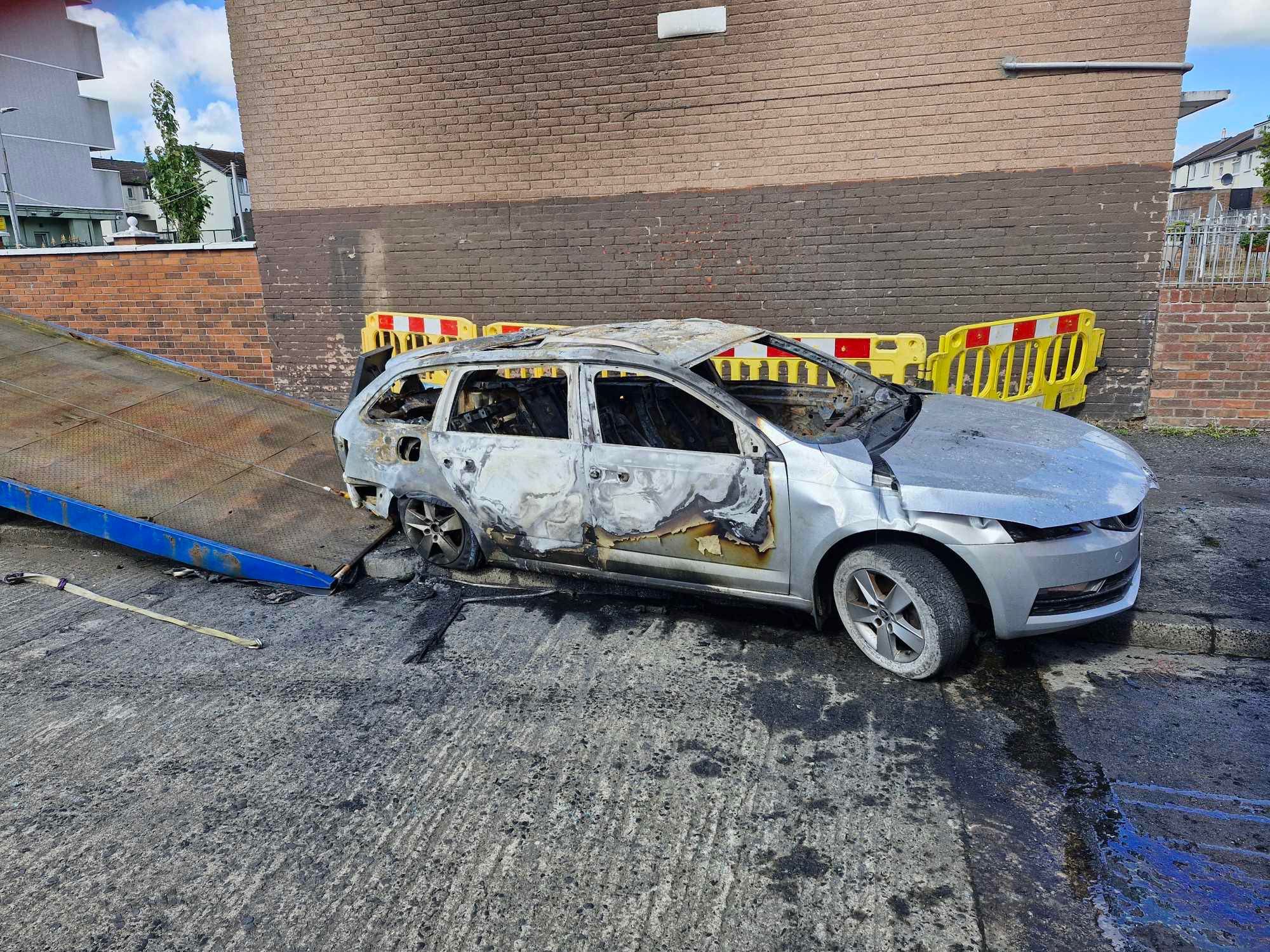 ARSON: The burned-out taxi in the New Lodge this morning