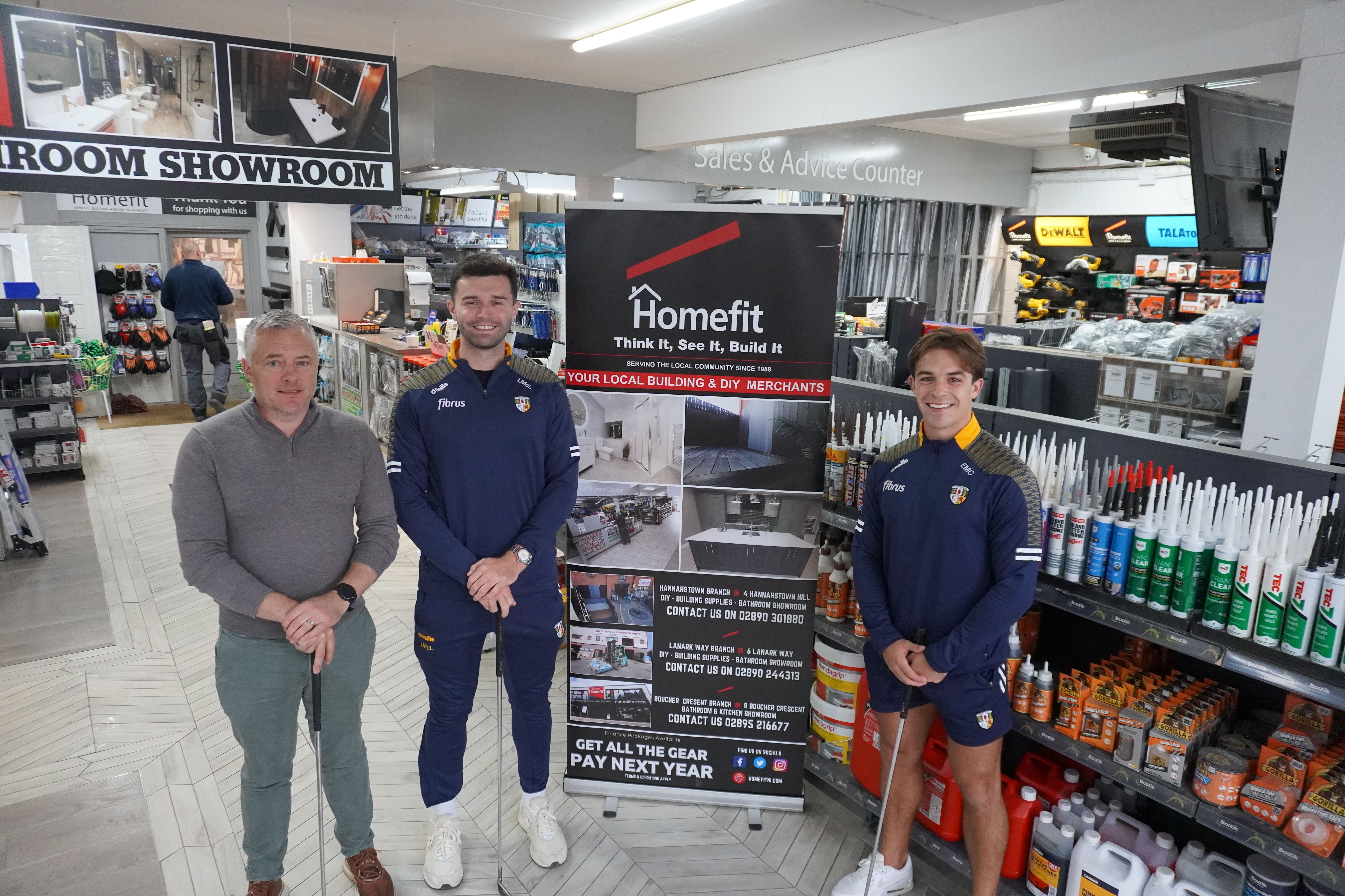 Antrim footballers Liam McLarnon and Eoghan McCabe with HomeFit owner John Kelly 