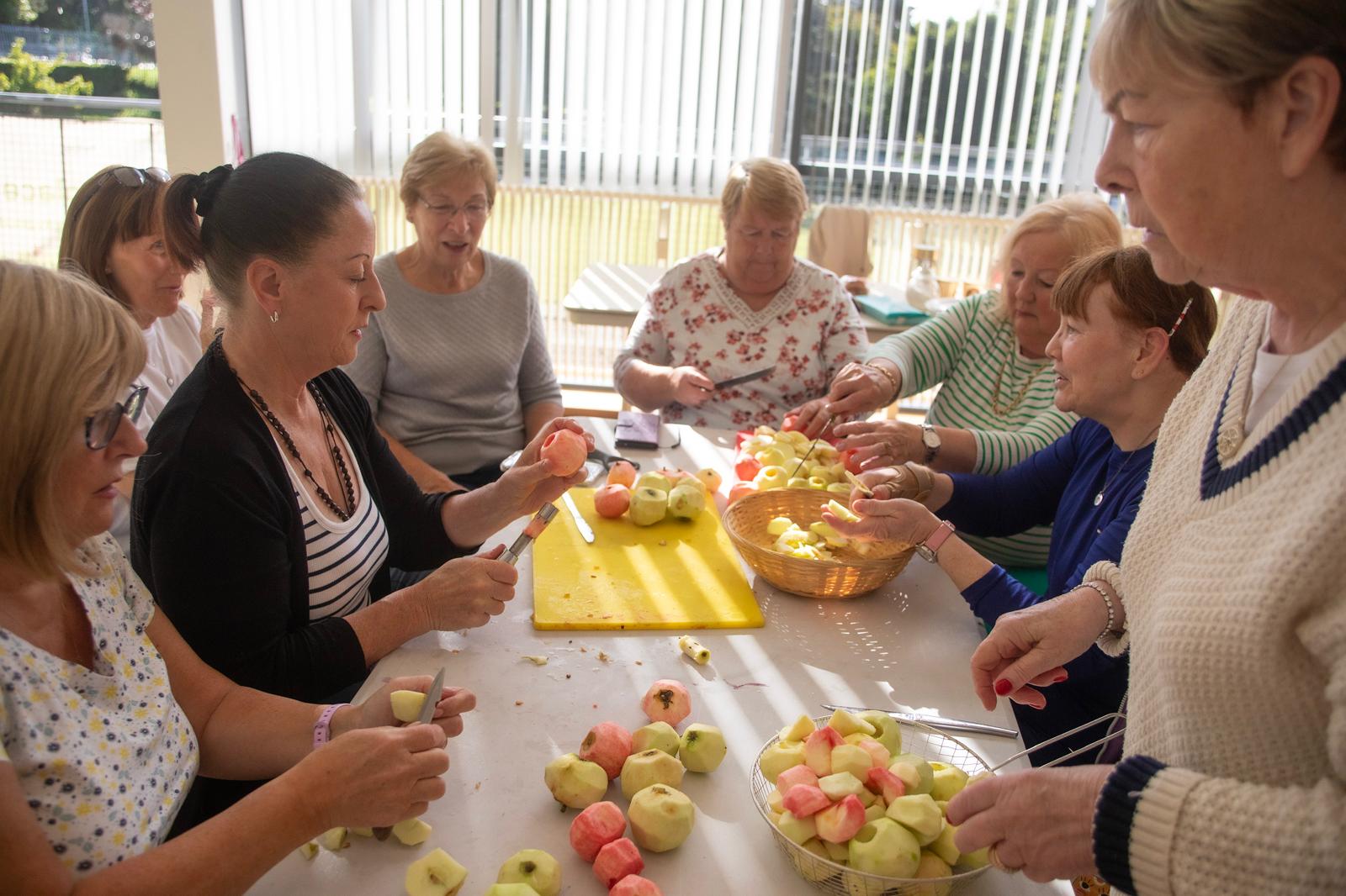 FLOUR POWER: The Hens\' Shed members preparing apple and plum cakes — with fruit collected in Musgrave Park — for their annual bazaar