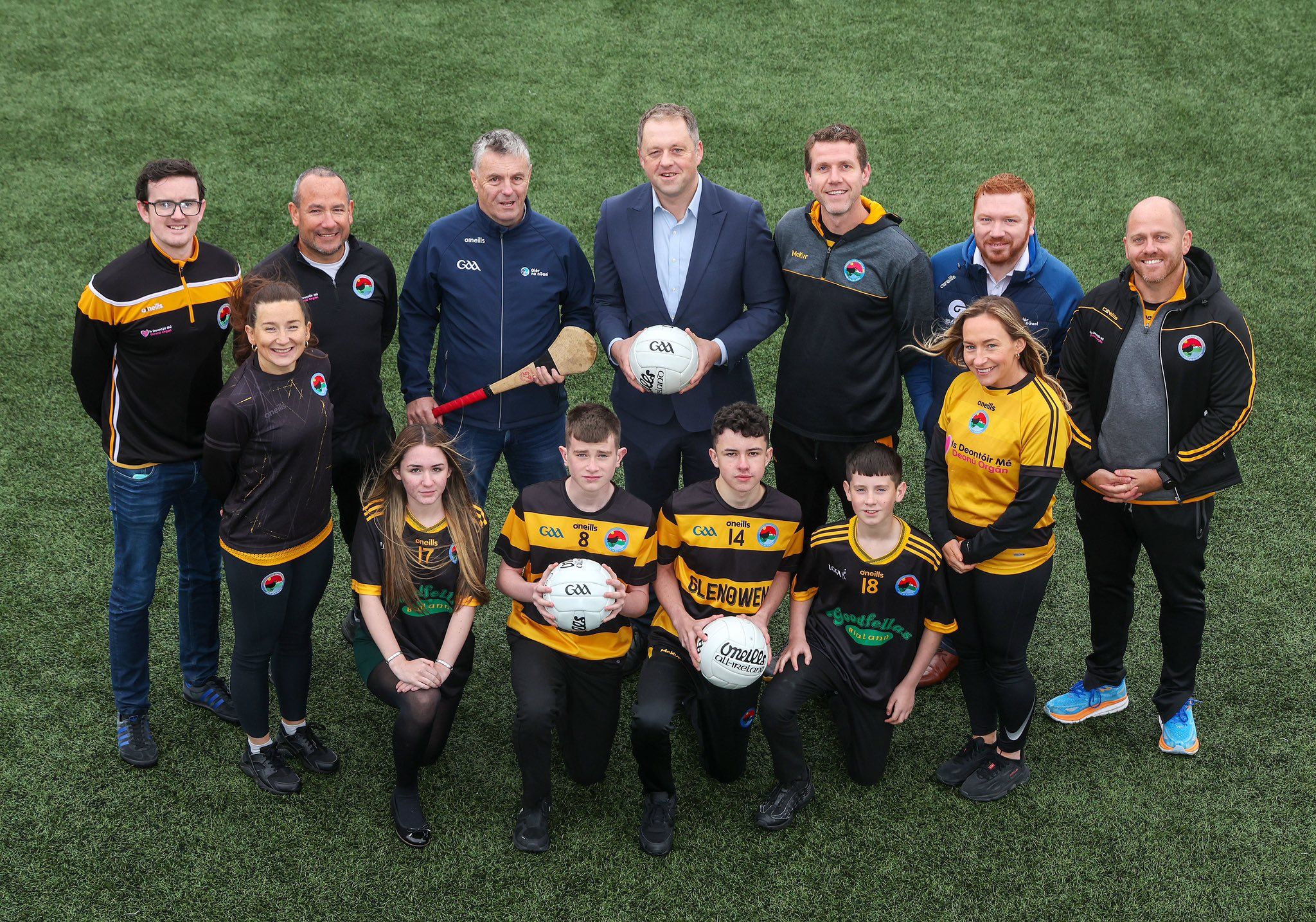 Minister for State Thomas Byrne TD with CLG Laochra Loch Lao players, coaches and members at West Belfast’s Spórtlann na hÉireann at the launch of today’s Irish language support scheme