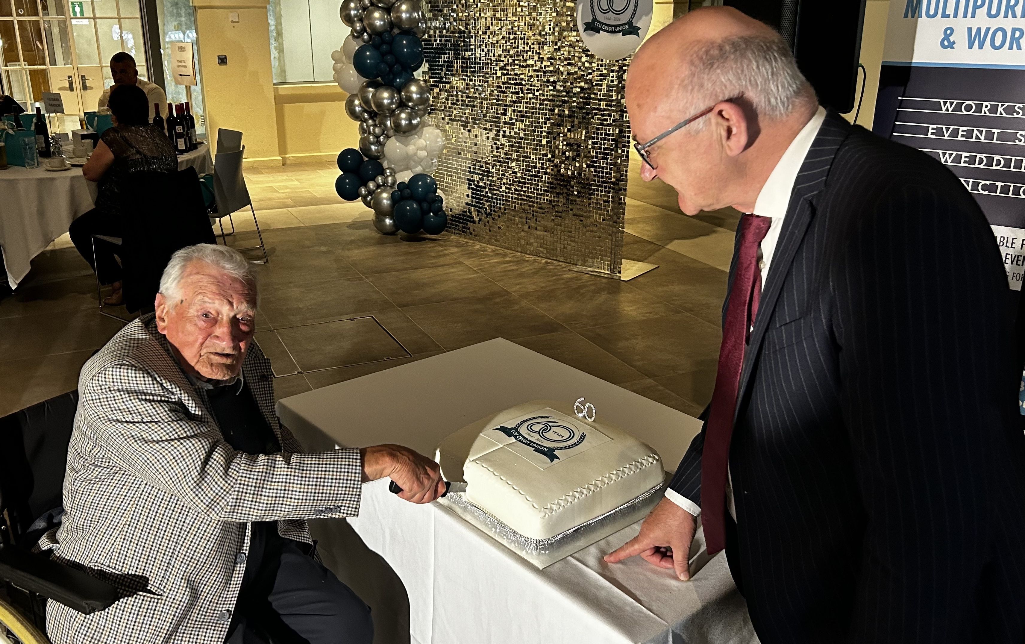 ICING ON THE CAKE: Terry Sharpe, founding member of Clonard Credit Union cuts the birthday cake at Friday\'s celebrations with CCU Chair Brian McCrory