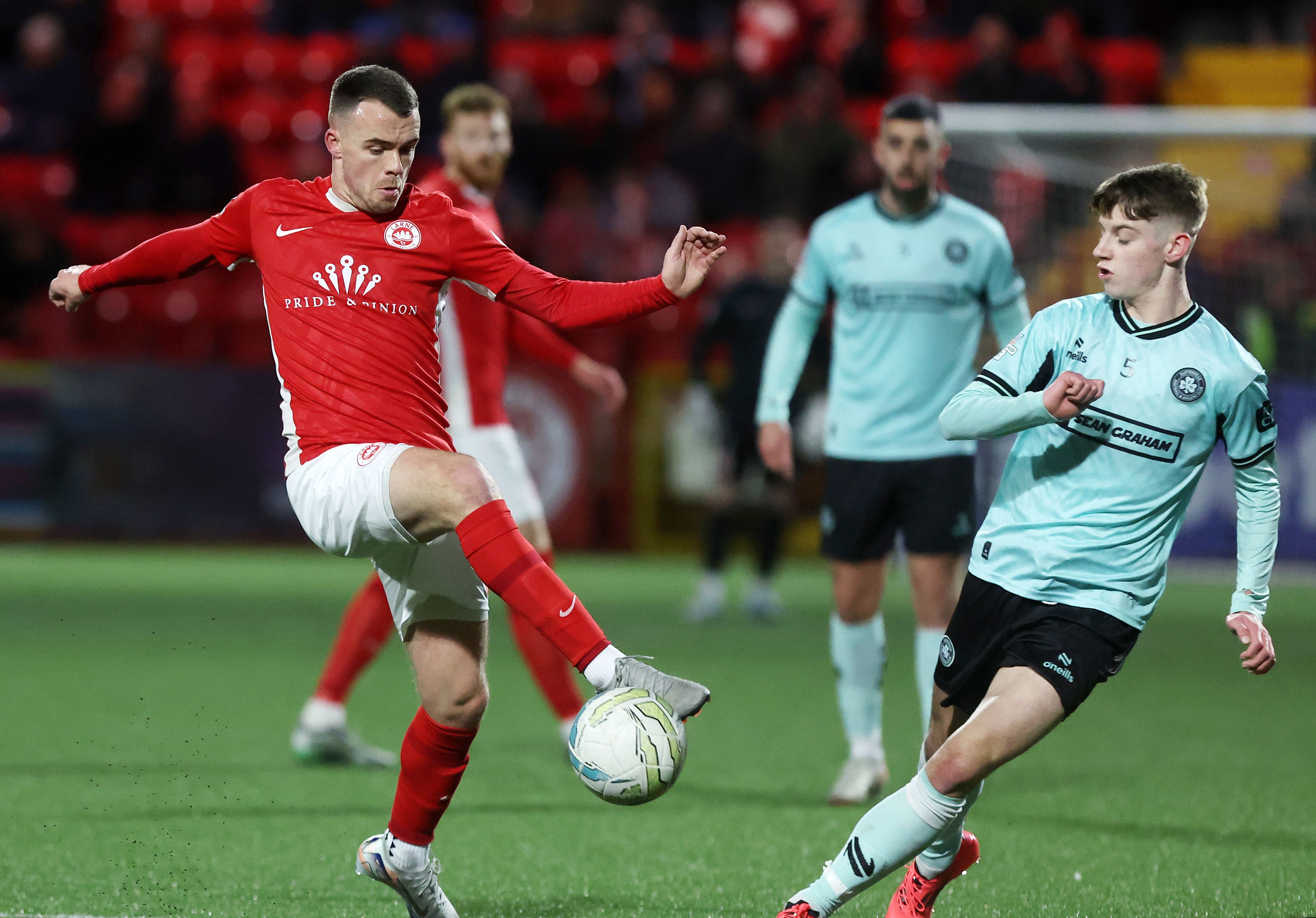 Chris Gallagher gets out in front of Ryan Corrigan during Larne\'s 2-0 win over Cliftonville on Friday 