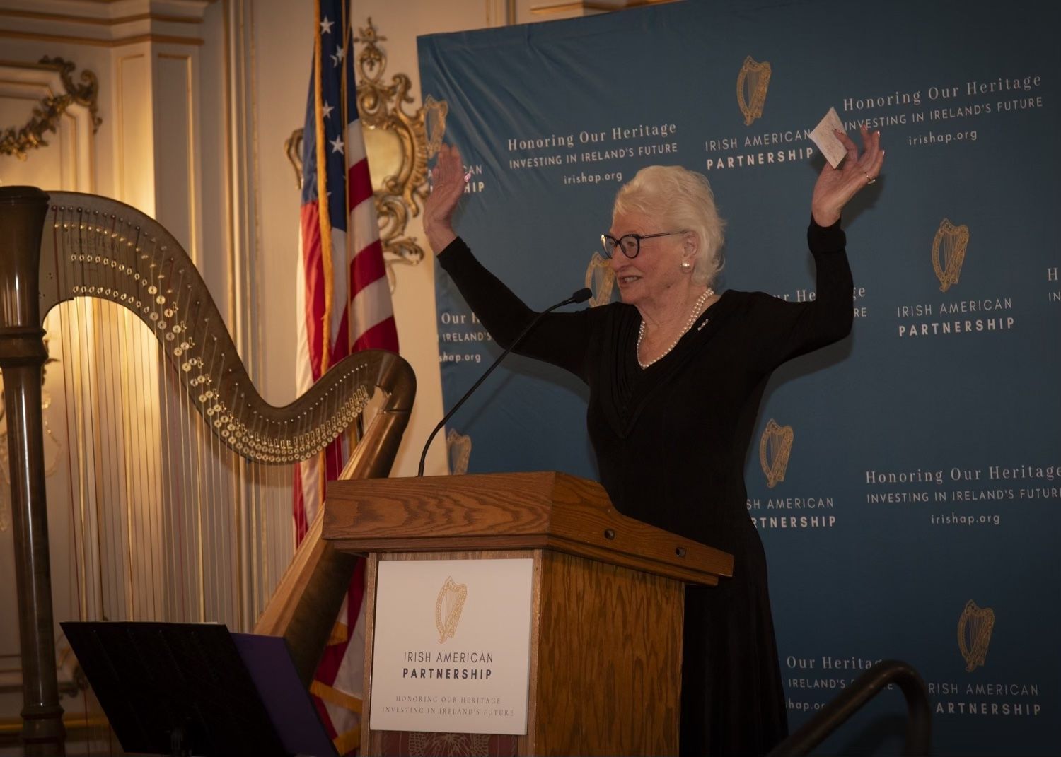 CHAMP: Mary Peters, in her famed arms aloft pose, salutes the Irish American Partnership Nollaig na mBan breakfast attendees