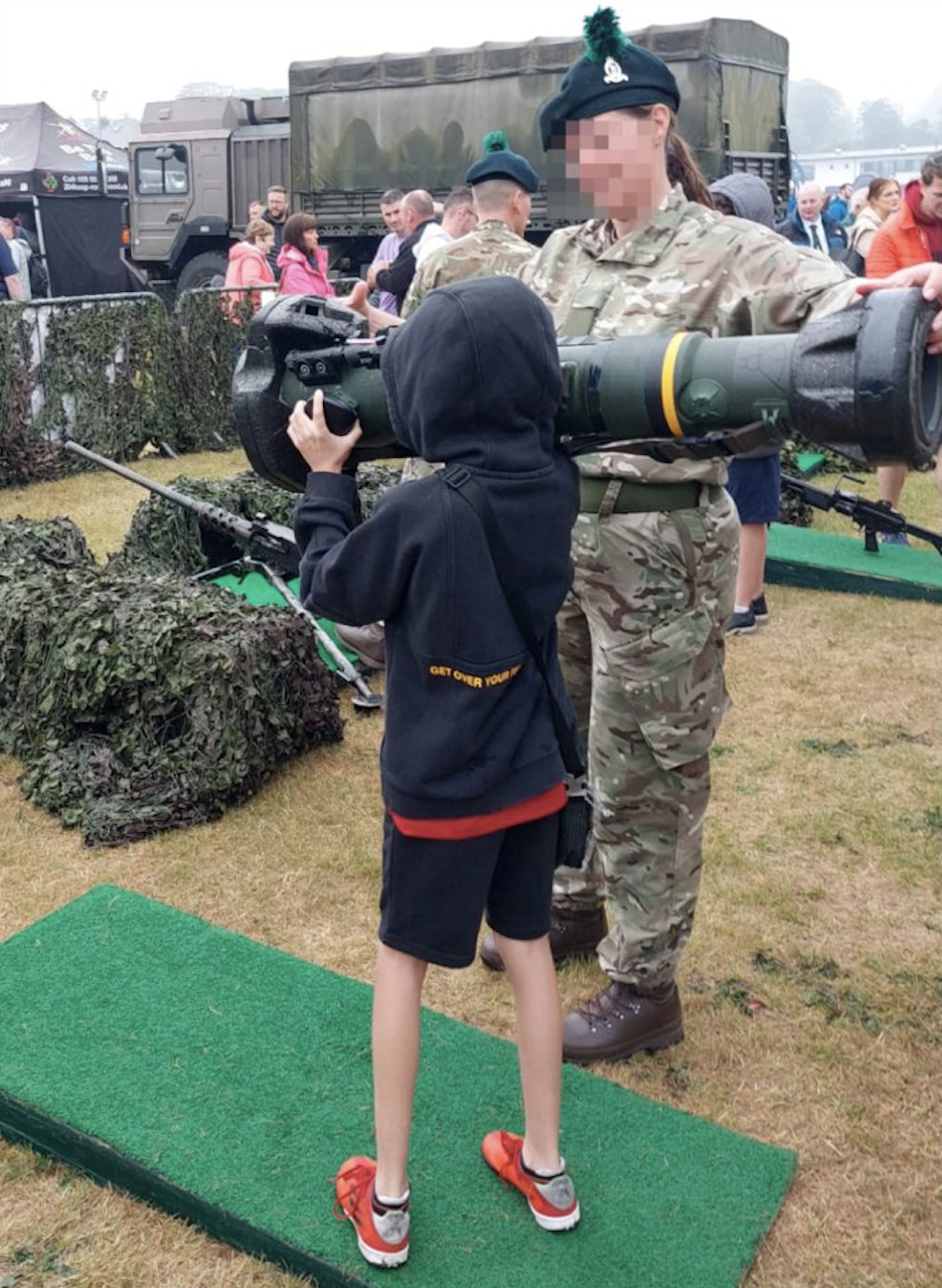 PIECE OF CAKE: A British Army instructor teaches a child to use a shoulder-launched missile on Armed Forces Day in Bangor