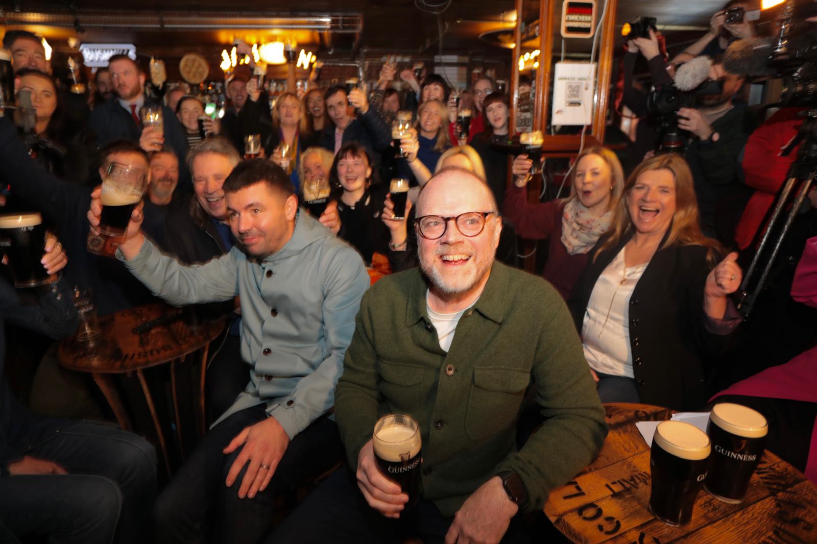 SLÁINTE: Writer Rich Peppiatt and producer Trevor Birney surrounded by well-wishers in Maddens Bar this afternoon