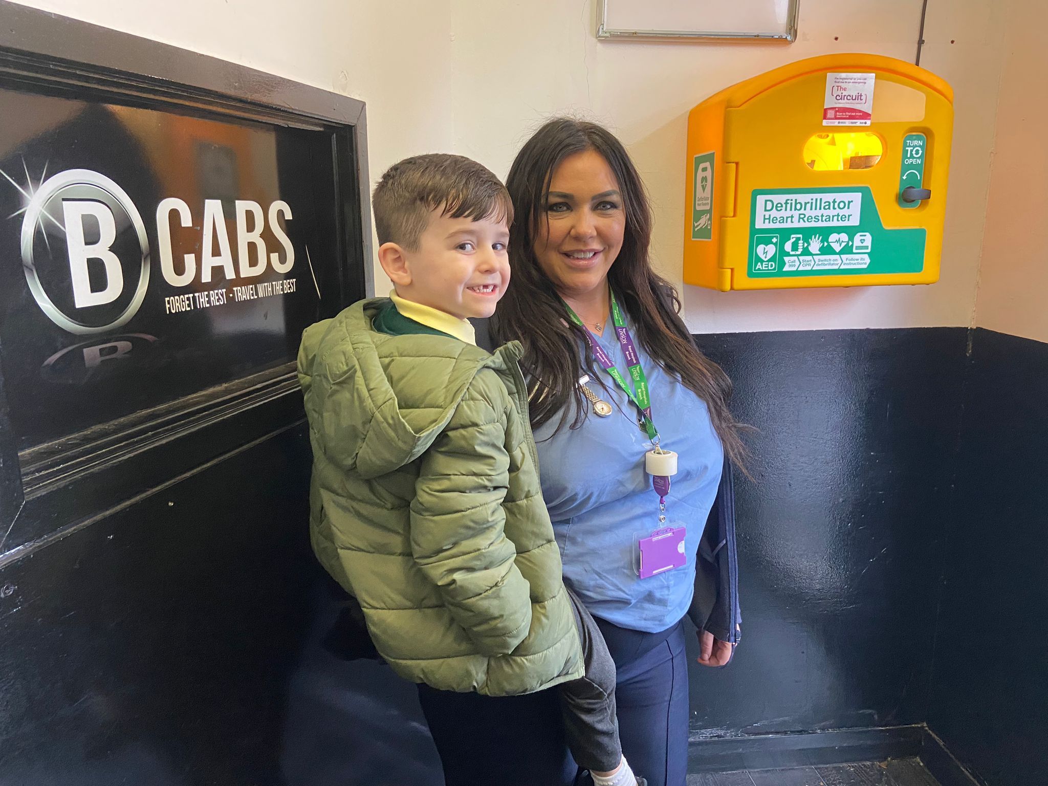 NEW DEFIB: Fiona McCarthy and her son Cinnan at the new defibrillator on the Antrim Road at the entrance to B Cabs