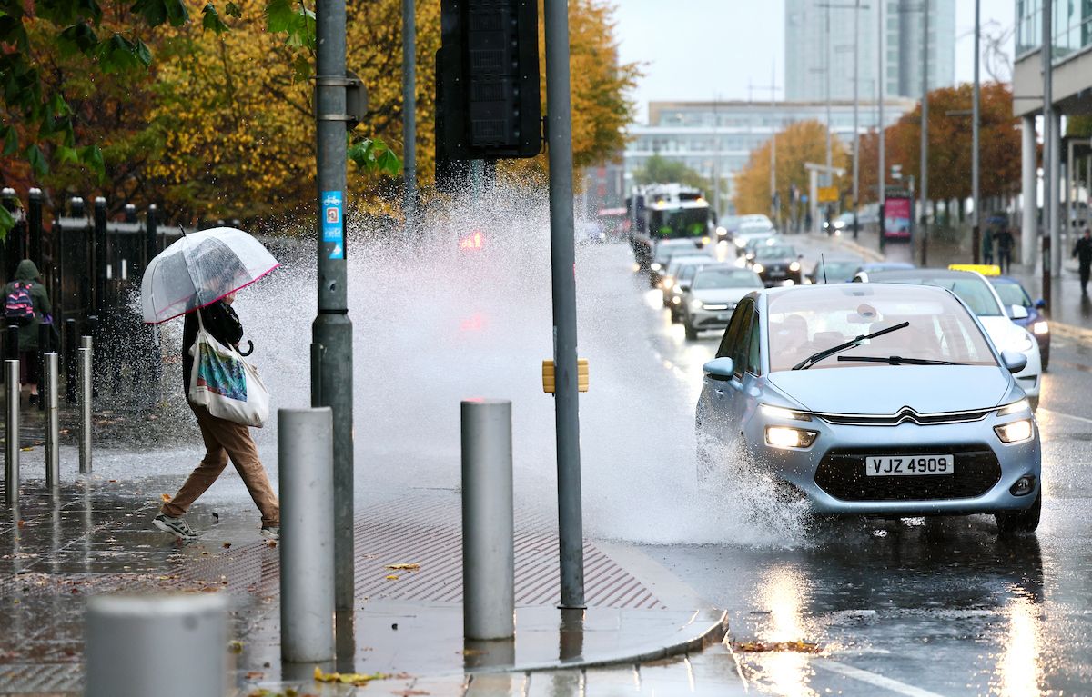 STORM AMY: A pedestrian battles the weather on Oxford Street in Belfast city centre on Friday