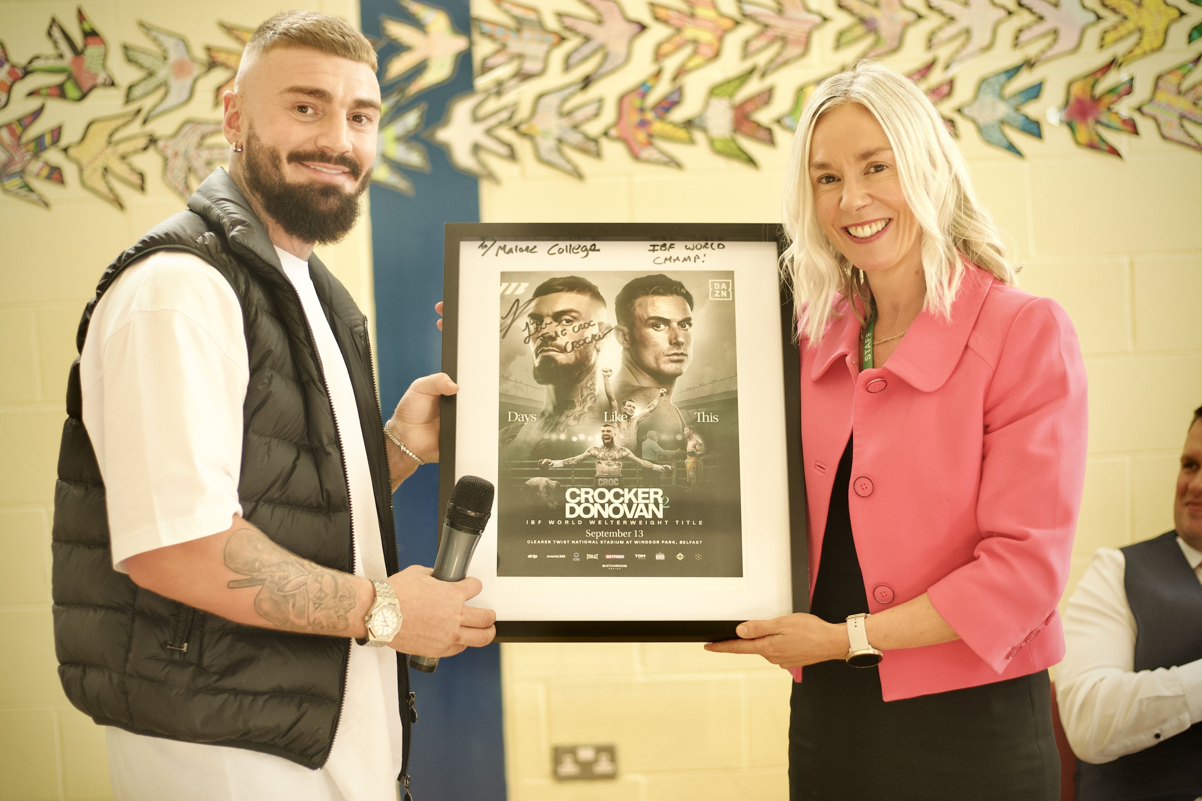 WELCOME BACK: Lewis Crocker makes a special presentation to Mrs Leslie during his return to his old school