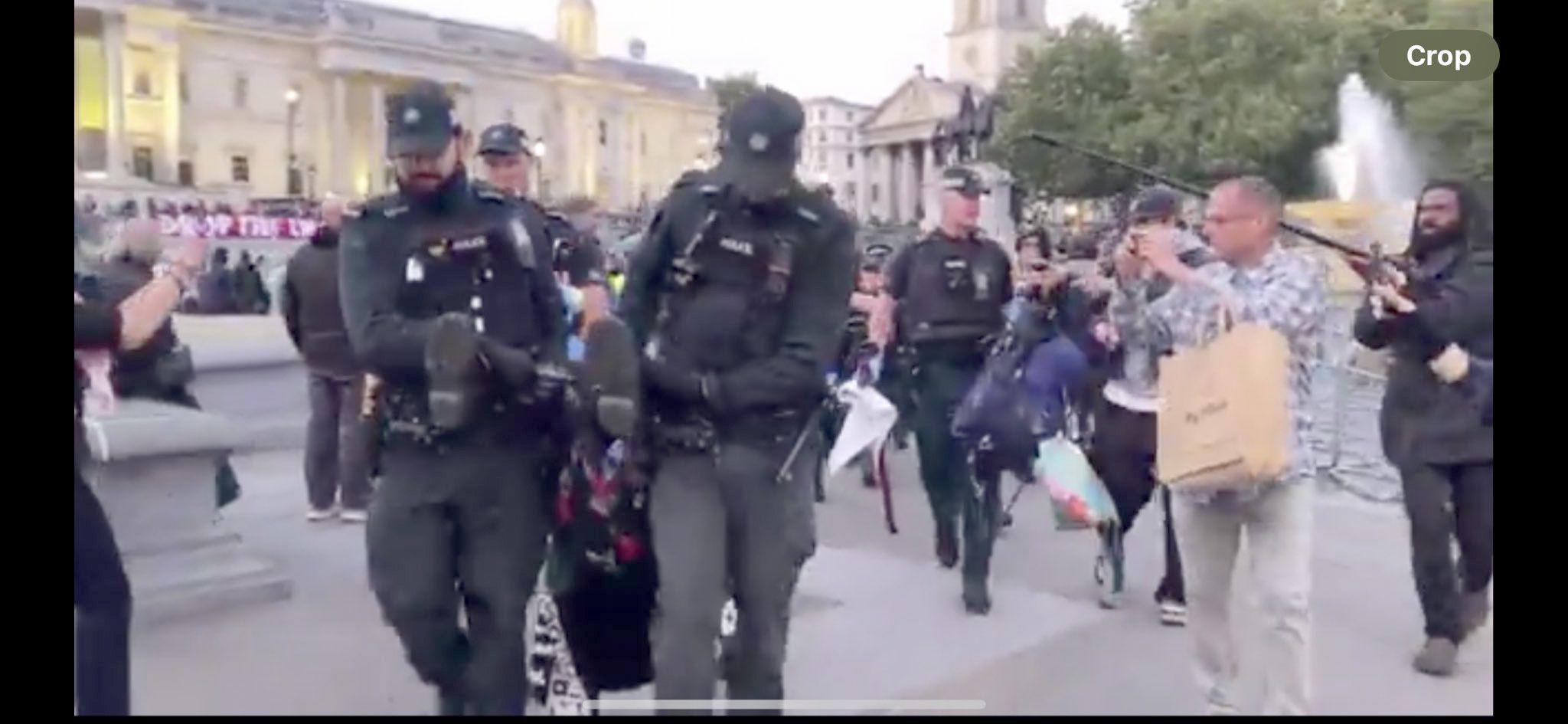 MOBILE UNIT: PSNI officers arresting an elderly protester in Trafalgar Square on Saturday