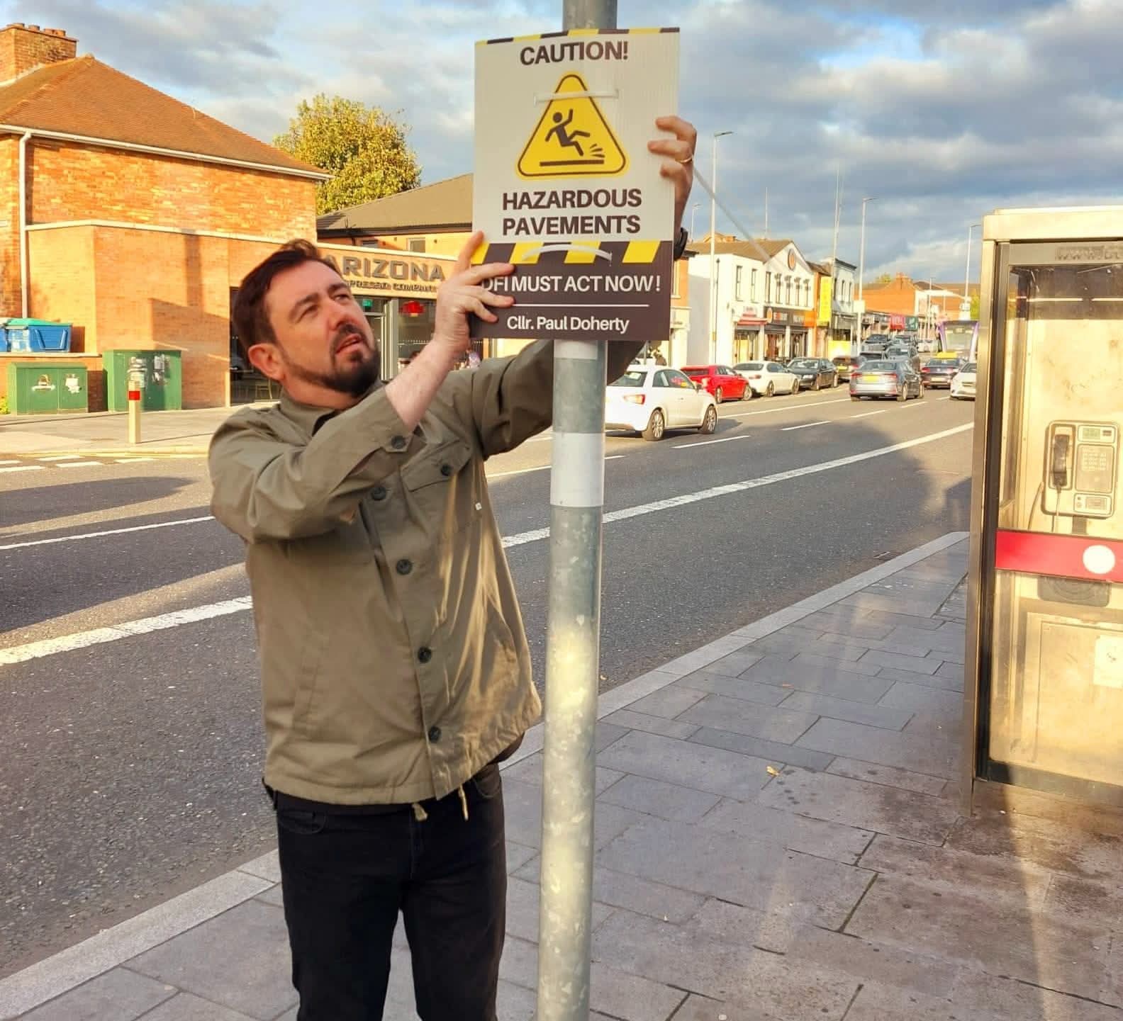 SLIPPY PAVEMENTS: Councillor Paul Doherty on the Andersonstown Road