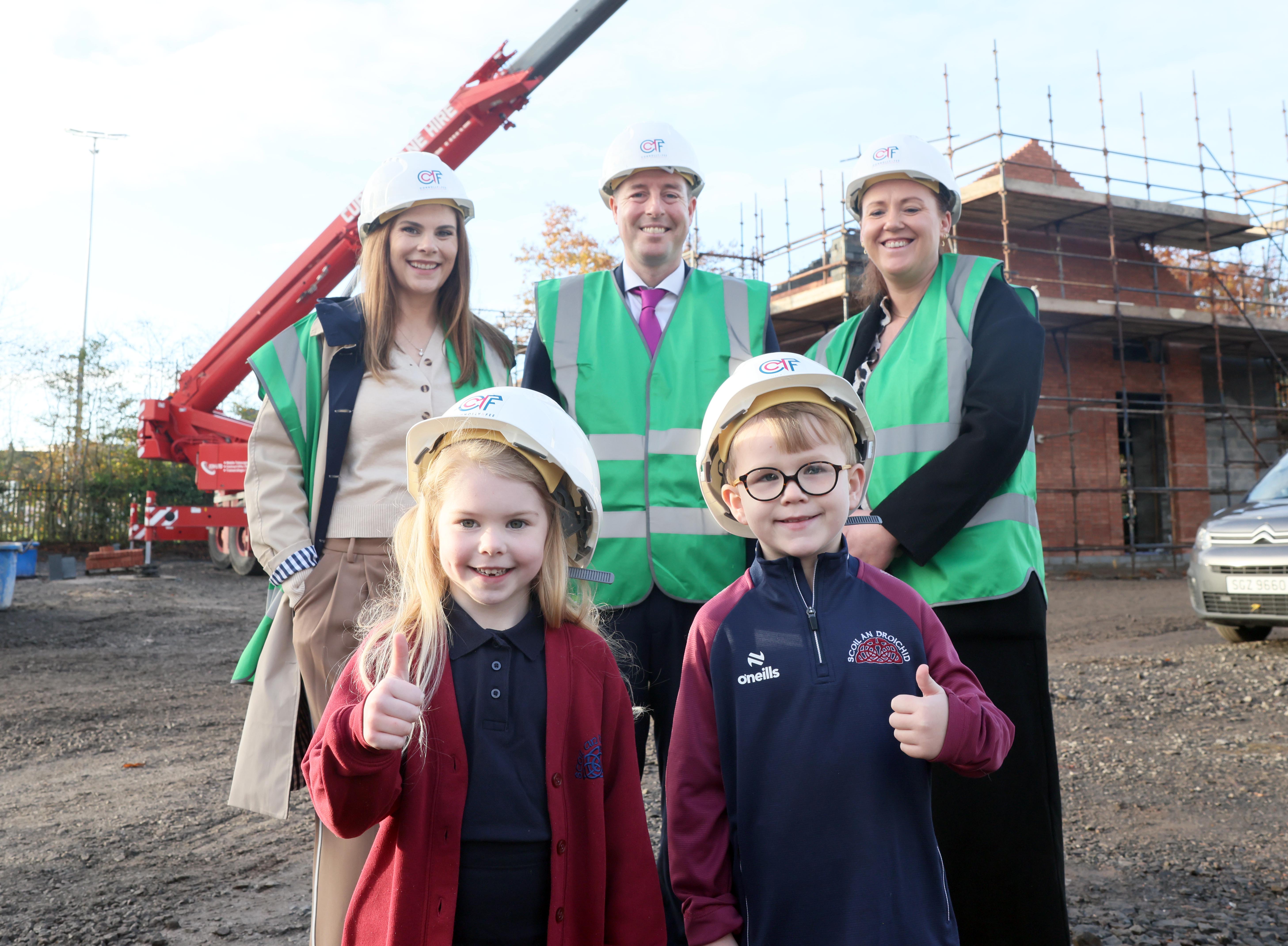SITE VISIT: Principal Claire Donnelly, Education Minister Paul Givan and Vice Principal Aisling Nic Giolla Bhéin with pupils Emer and Dualta