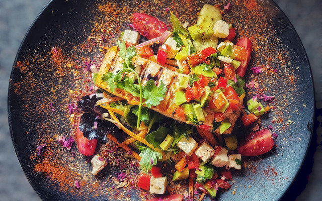 PLATING UP: Grilled salmon on mixed leaves salad with avocado and feta