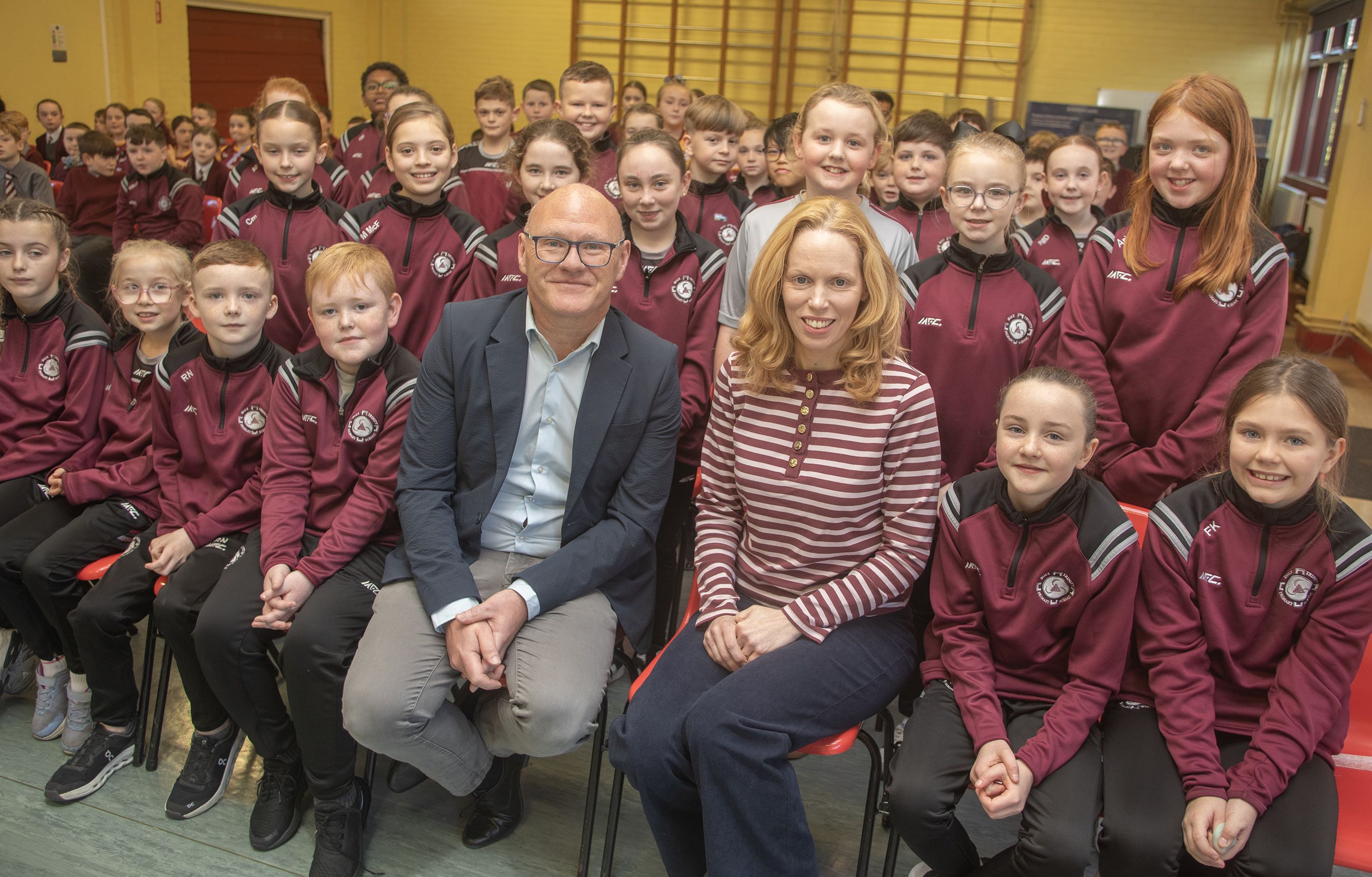EDUCATION: West Belfast MP Paul Maskey and Fiona Payne (Education and Engagement Officer at Westminster Parliament) with pupils at Holy Trinity PS
