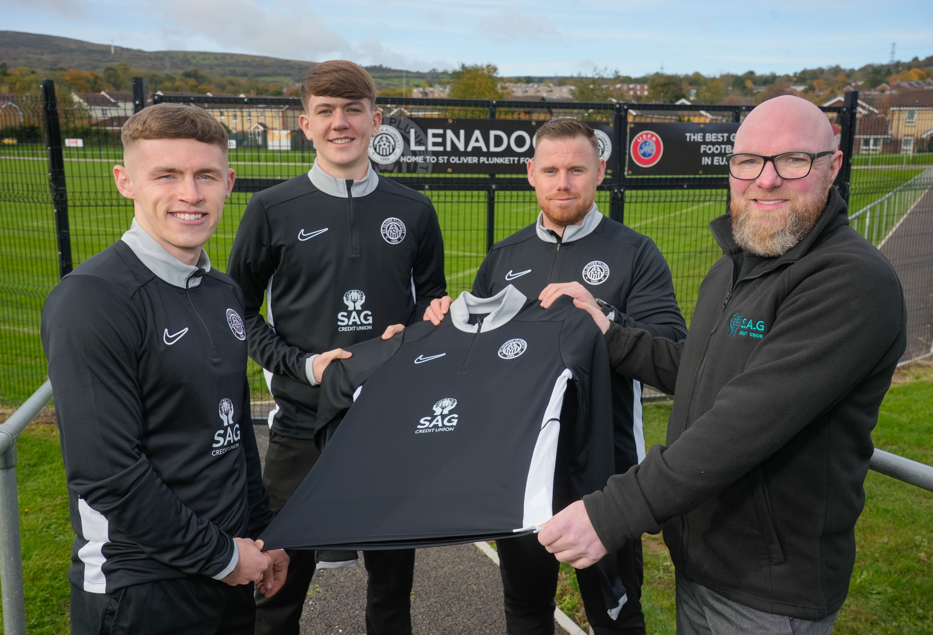 PRESENTATION: Seamus Judge from SAG Credit Union presents the new jerseys to St Oliver Plunkett\'s Sean McCullough (club captain) Miceal Vallely, and Eoghan McGonigle (first team manager)