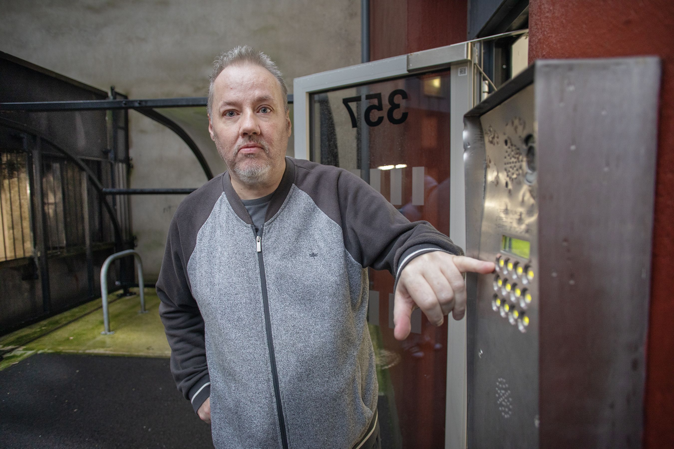 EMERGENCY: Gerard Moore at the broken intercom system at Brookfield Mill Apartments on the Crumlin Road