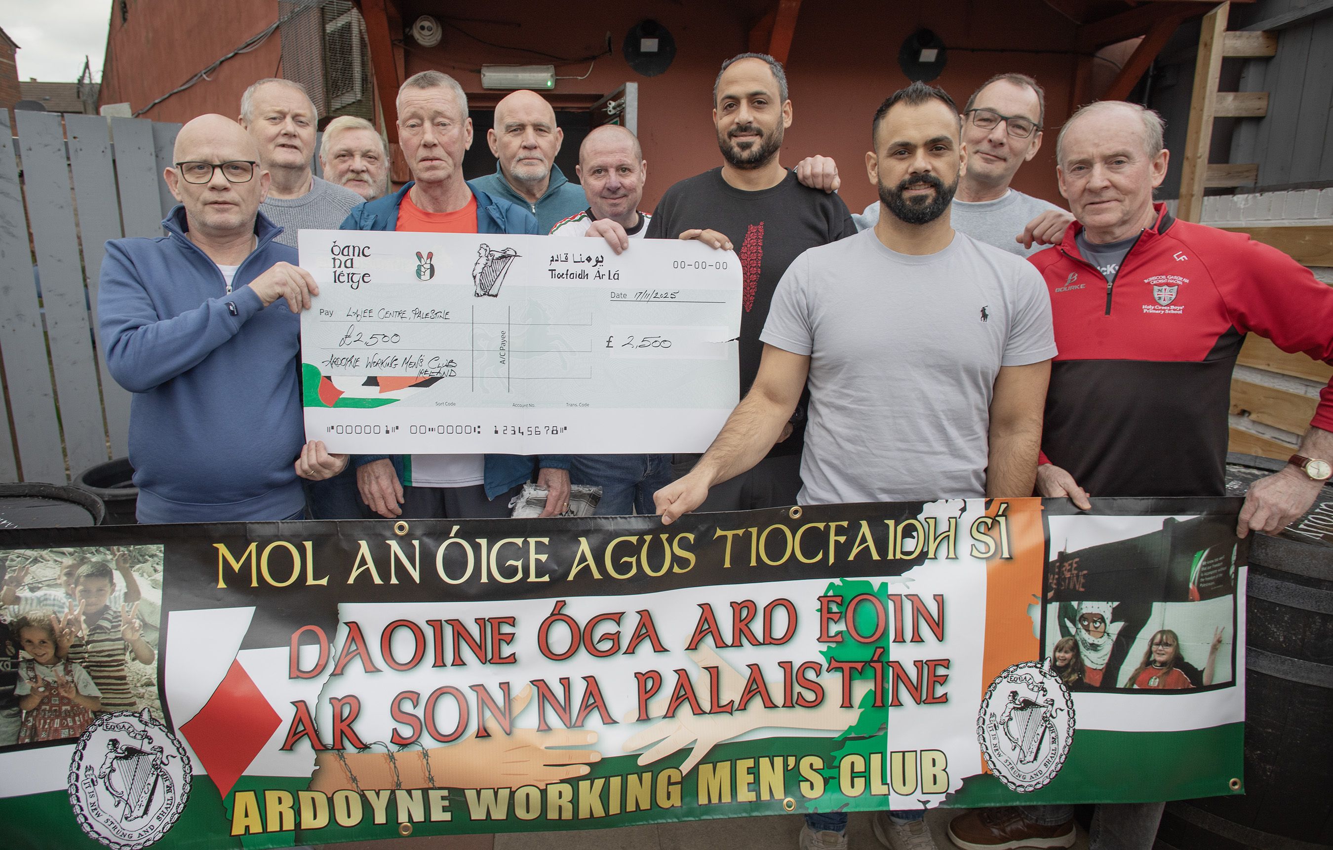 SUPPORT: Members of Ardoyne Working Men\'s Club present a cheque for £2,500 to Mohammad Alazza, Director of the Lajee Center