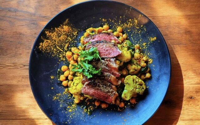 PLATING UP: Sliced Sirloin steak on curried chickpea and roasted cauliflower