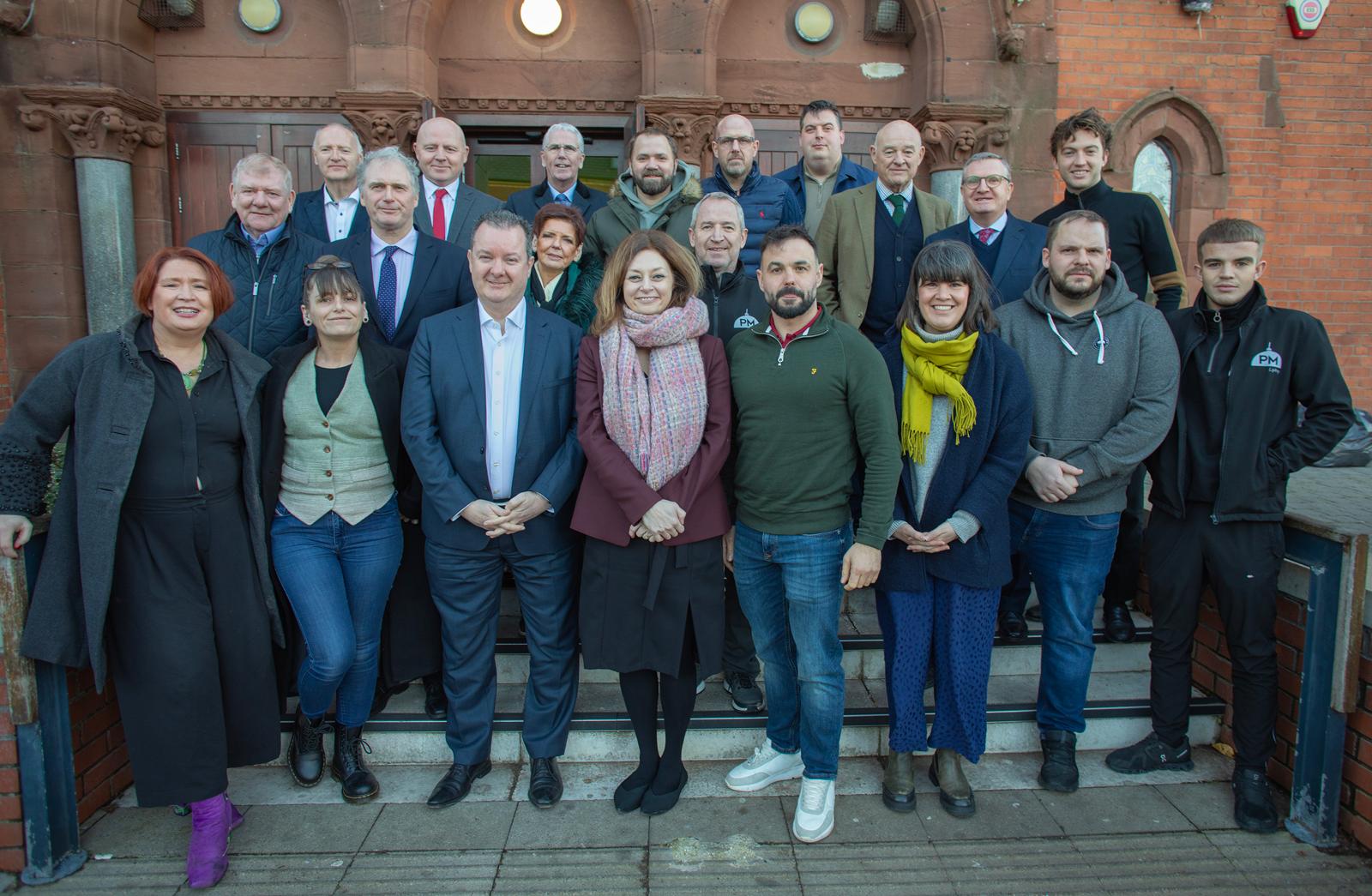 WARM WELCOME: Kieran Donoghue and Susan O\'Kane of Invest NI pictured with local business owners who attended the latest in the series of West Belfast Roundtable gatherings