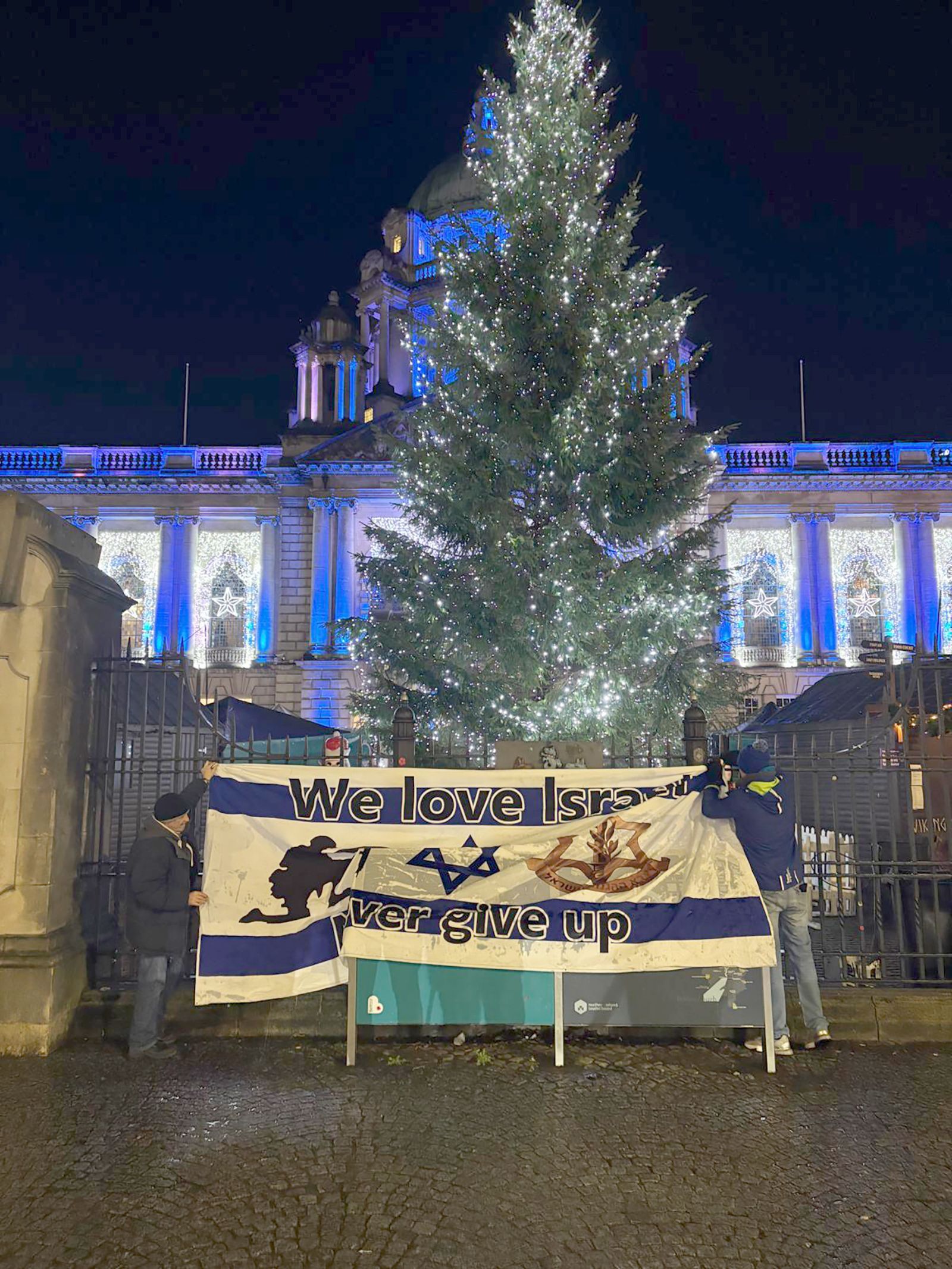 VIGIL: Loyalist protestors attached a pro-Israel flag to the City Hall gates as midnight approached