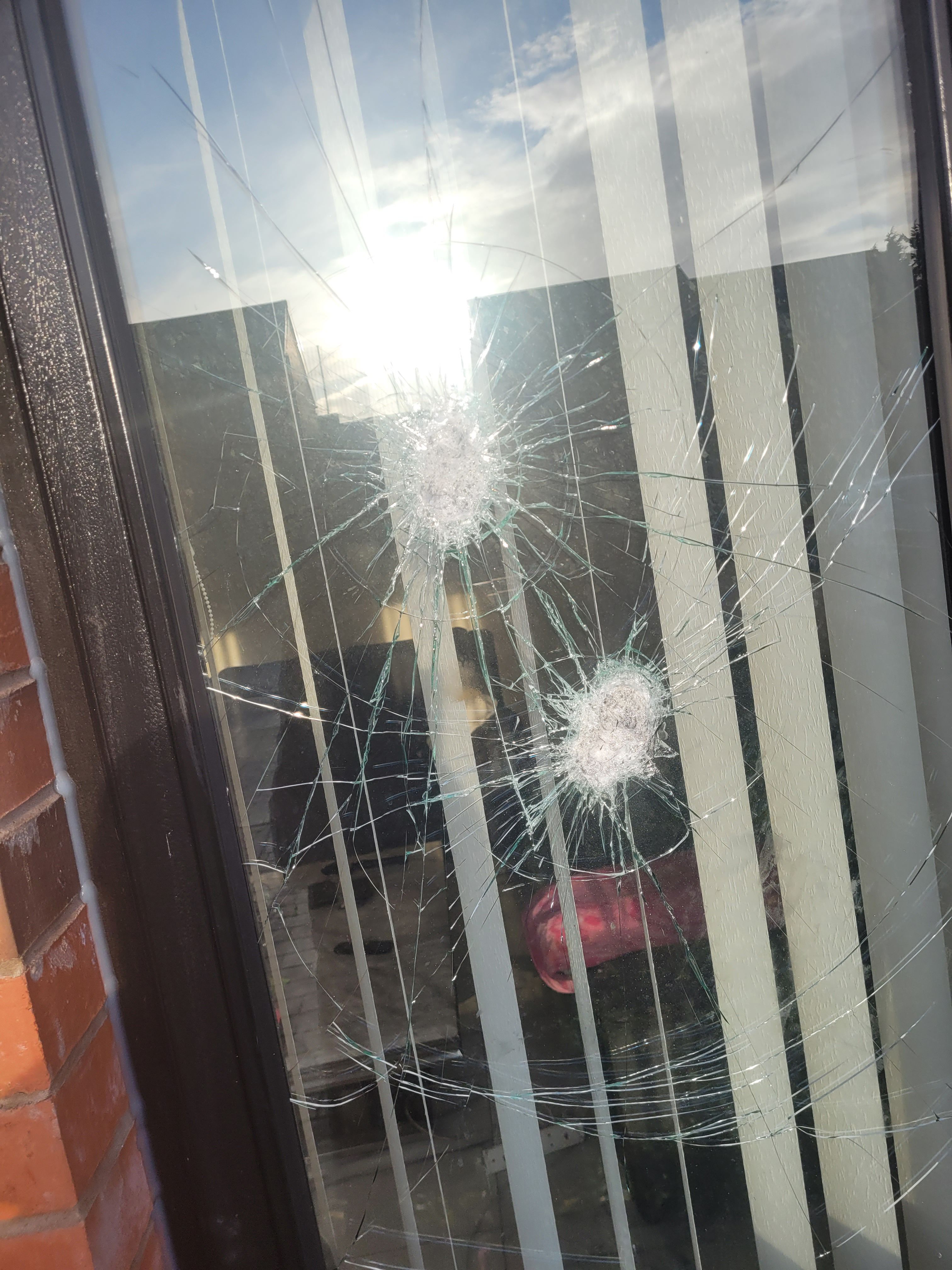 ATTACK: Smashed windows at the front of Michael\'s home